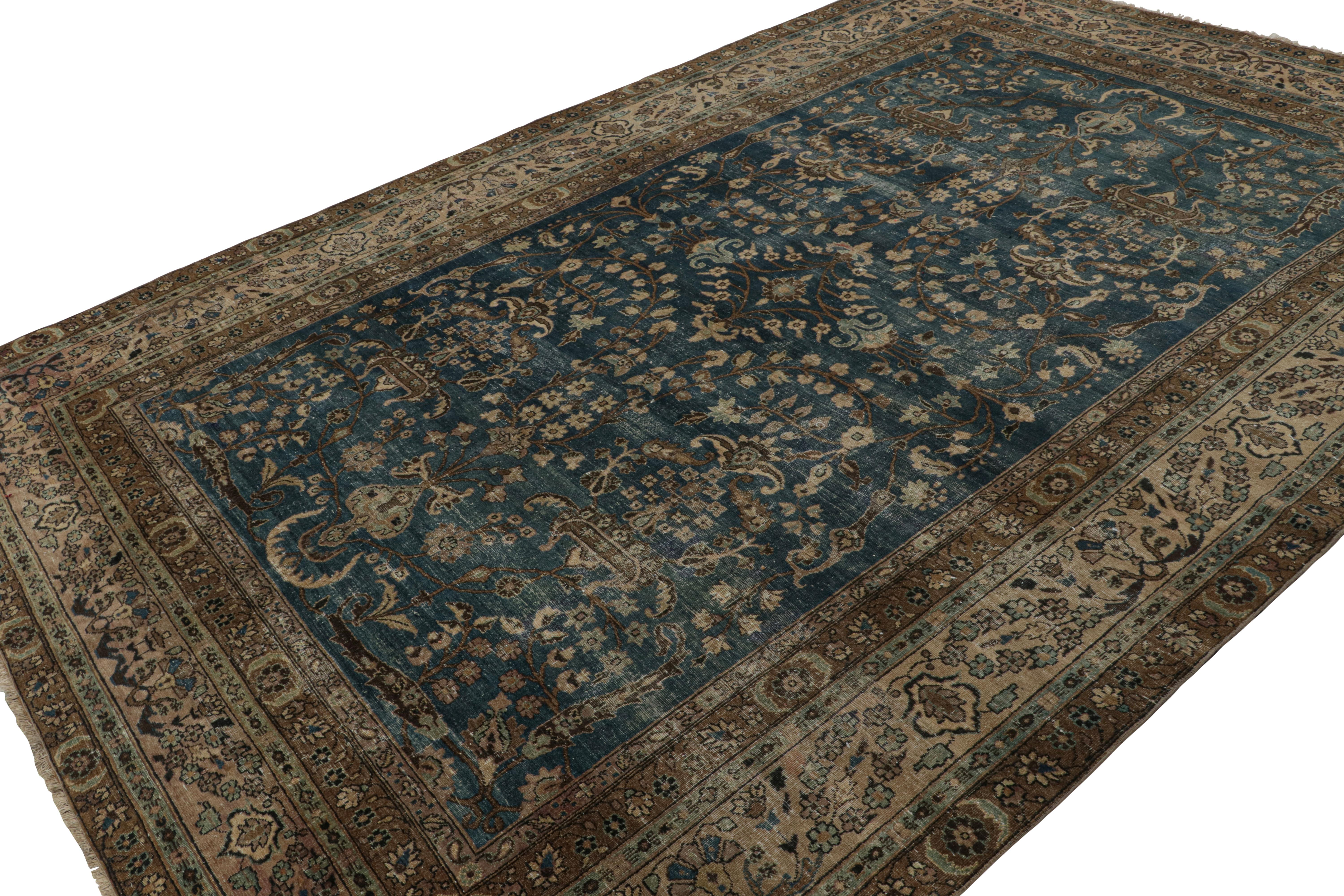 Hand-knotted in wool, this 8x12 antique Persian Doroksh rug, circa 1920-1930, has a subtle European sensibility to its floral patterns, almost like that of a Kashan and other provinces, making it all the more rare for a Doroksh as a subversive,
