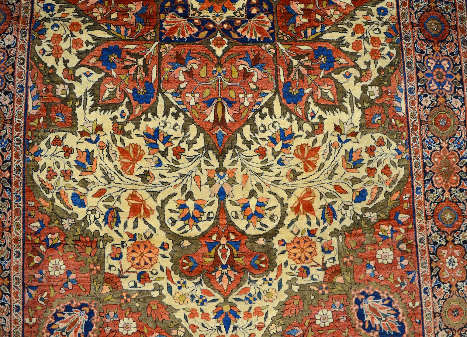This is an antique Persian Farahan carpet dating to circa 1890 in rich hues of red, cream, and light blue in an intricate design. This carpet utilizes pure handspun wool and organic vegetable dyes, it measures 4'1