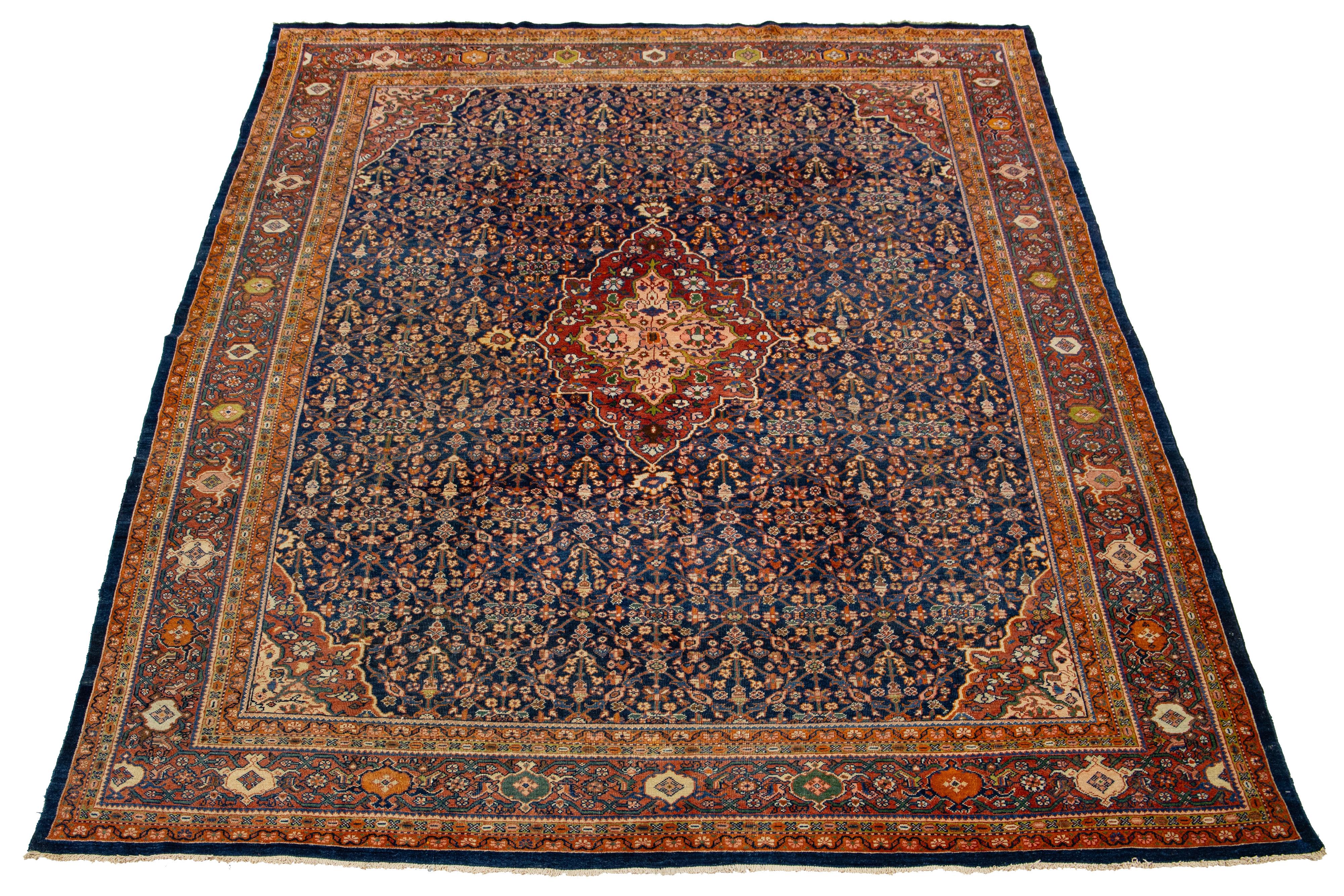 This is a beautiful hand-knotted wool Sarouk Farahan rug with a navy blue field. The rug features a rust-colored frame with multicolor accents and a classic allover floral design.

This rug measures 8'10