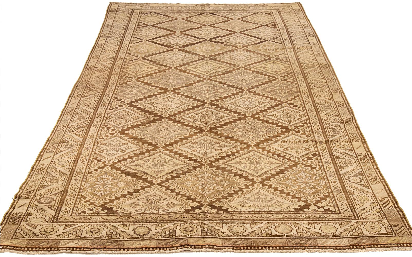 Antique Persian rug handwoven from the finest sheep’s wool and colored with all-natural vegetable dyes that are safe for humans and pets. It’s a traditional Farahan weaving featuring a lovely ensemble of tribal details in ivory medallions over a
