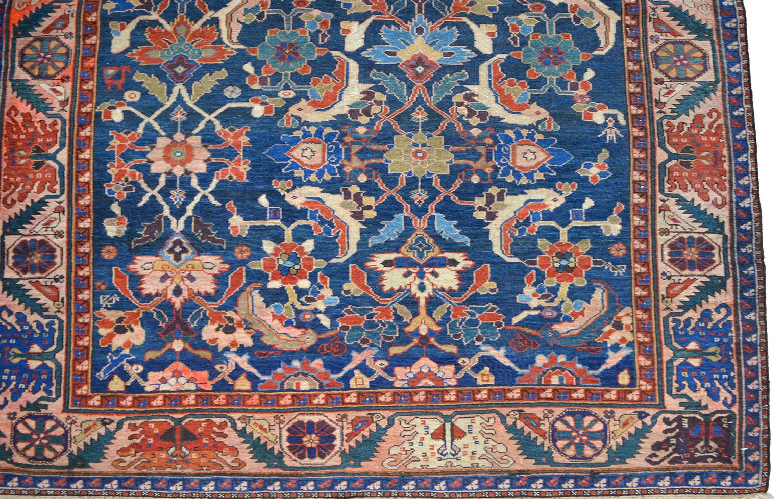 This antique Persian Farahan Sarasar carpet circa 1880 in pure handspun wool and organic vegetable dyes is hand knotted in a Persian Farahan weave, and the overall or “Sarasar” design is characterized by geometric flowers in red and blue tones.