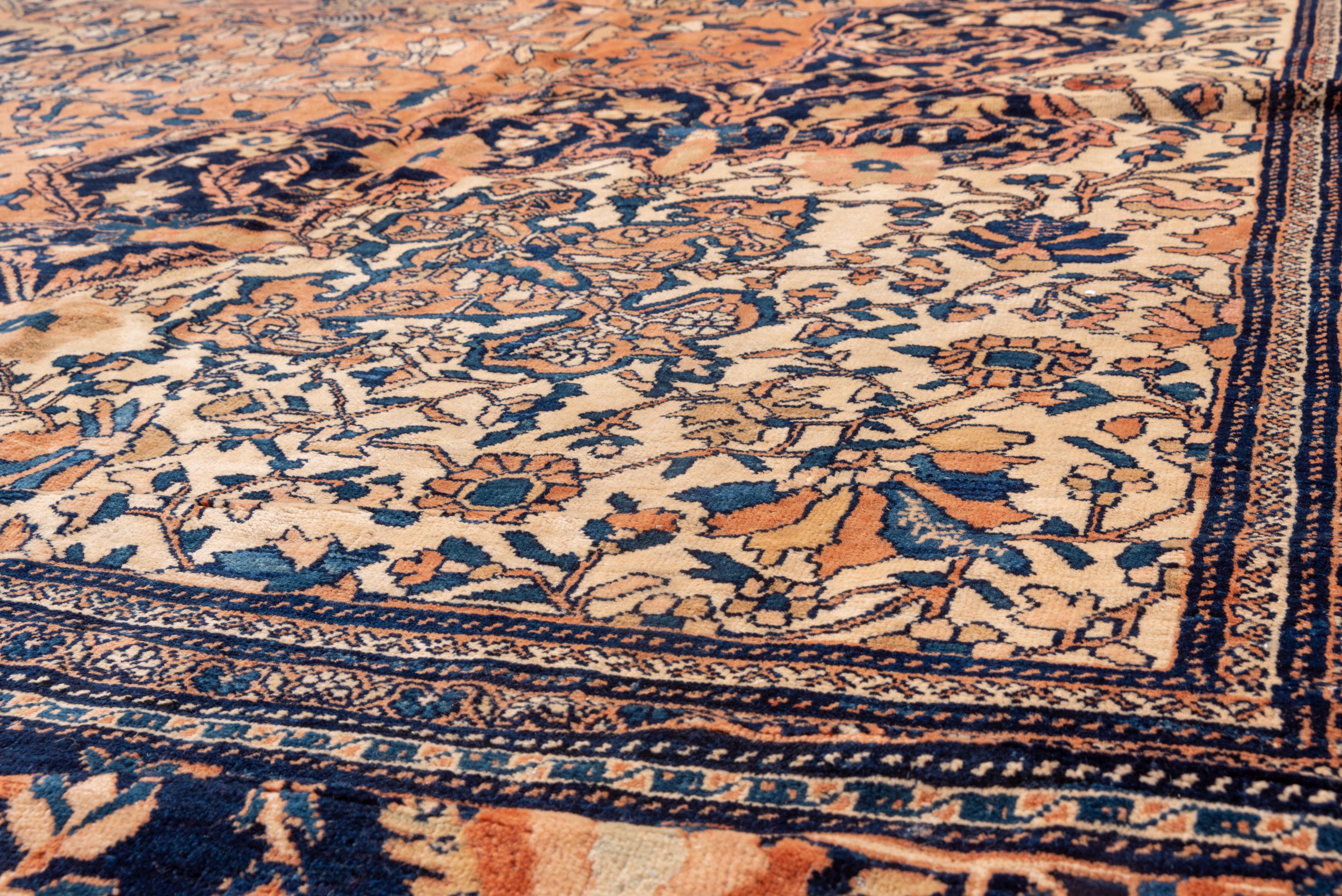 Dies ist ein schönes Beispiel für die rustikalen Teppiche aus dem Arak-Gebiet in Westpersien, die nach den höchsten städtischen Standards hergestellt wurden. Der hellrosafarbene Grund ist symmetrisch mit einem kleinen Blumen- und Weinrebenmuster