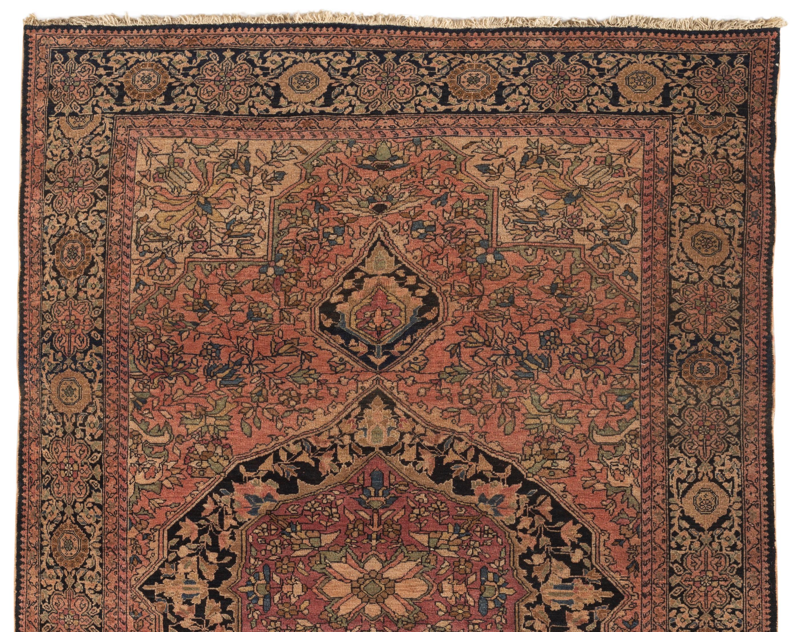 Antique Persian Farahan Sarouk rug, circa 1880. Sarouk rugs come from west central Persia. A delightful small scatter rug with a central design surrounded by floral motifs with four soft ivory spandrels enclosed within a border repeating the floral