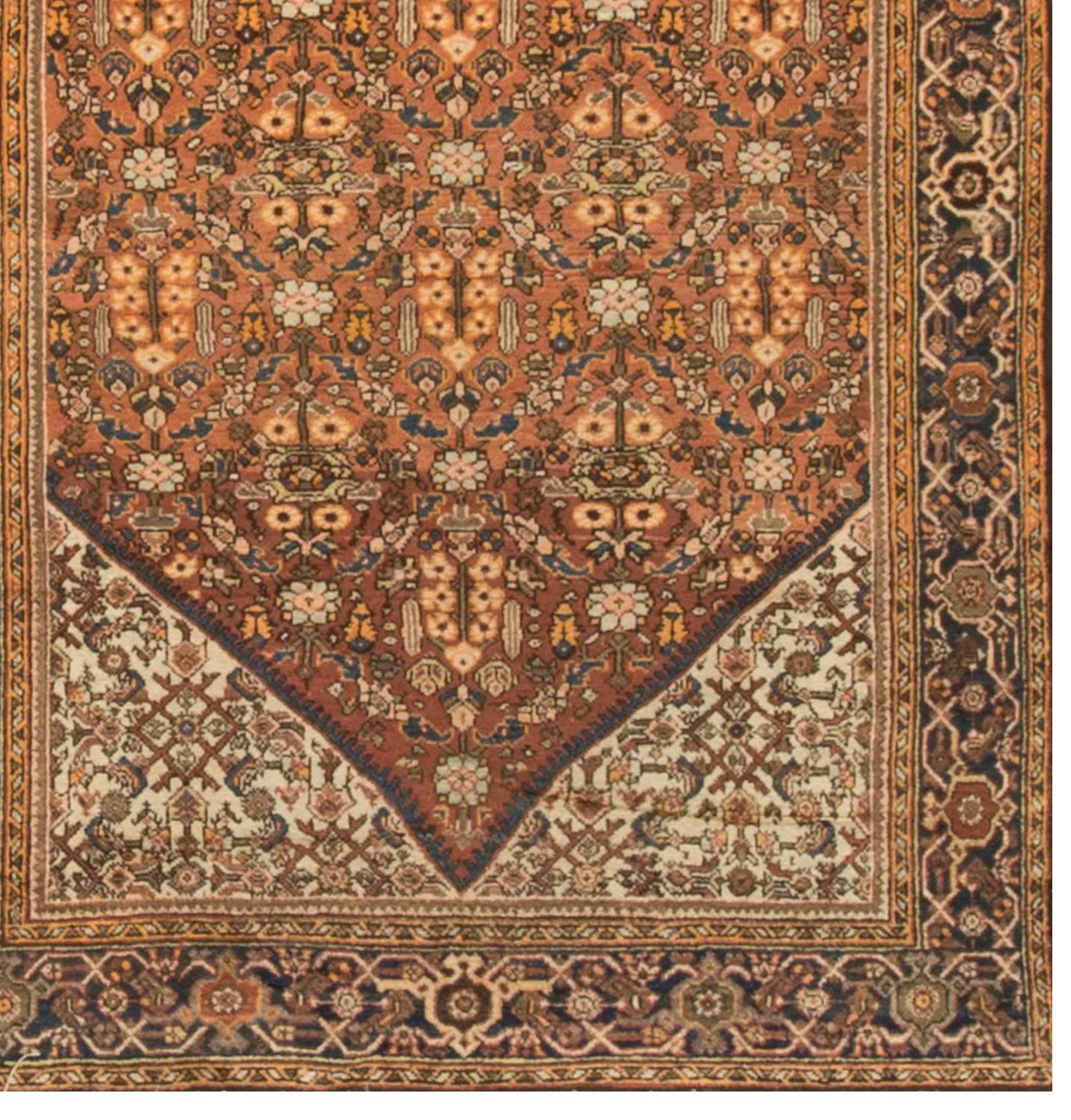 The main diamond shape ground filled with floral and vine designs, enclosed inside floral based ivory spandrels all within a dark blue main border creates this most attractive handwoven Fereghan rug. 