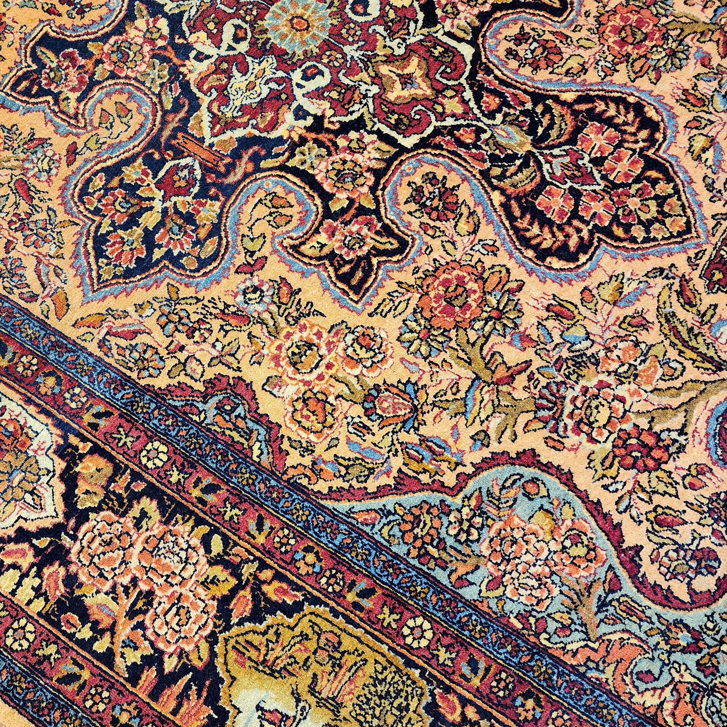 This exceptional antique Persian rug is a masterpiece of fine handwoven artistry, featuring the luxurious combination of Kashan wool in a striking gold and navy color palette. With meticulous craftsmanship, the rug measures 4 feet 6 inches by 6 feet