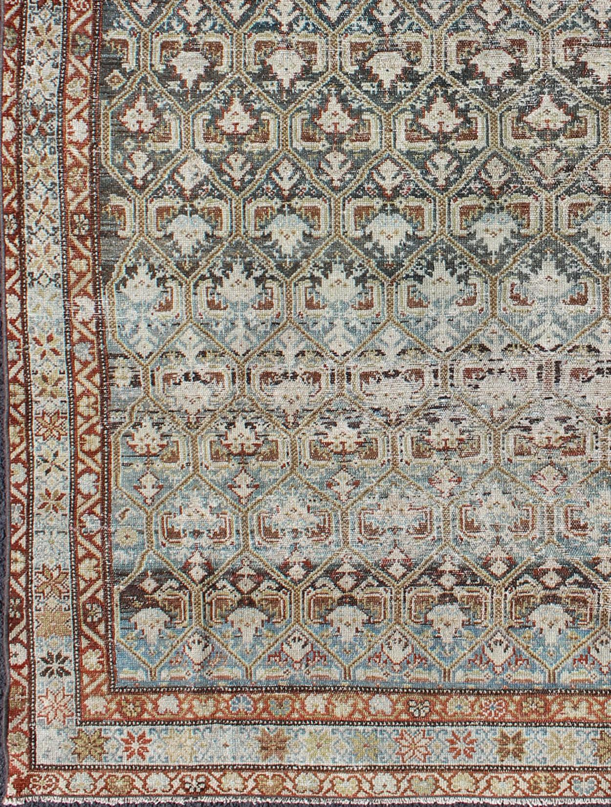 distressed antique rug from Persia in various color tones, rug en-176573, country of origin / type: Iran / Senneh, circa 1900.

This incredible antique Persian Senneh rug was handwoven circa 1900 and bears a remarkably unique all-over design and