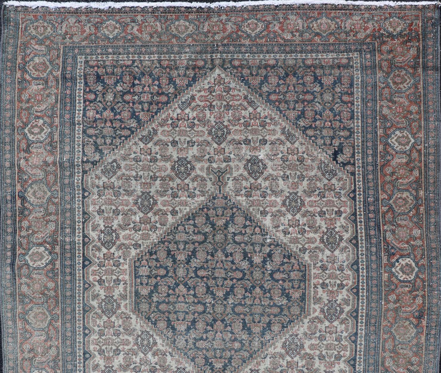Medallion geometric design Senneh antique rug from Persia in various color tones, rug R20-0822, country of origin / type: Iran / Senneh, circa 1910.

This incredible antique Persian Senneh rug was handwoven circa 1910 and bears a remarkably unique