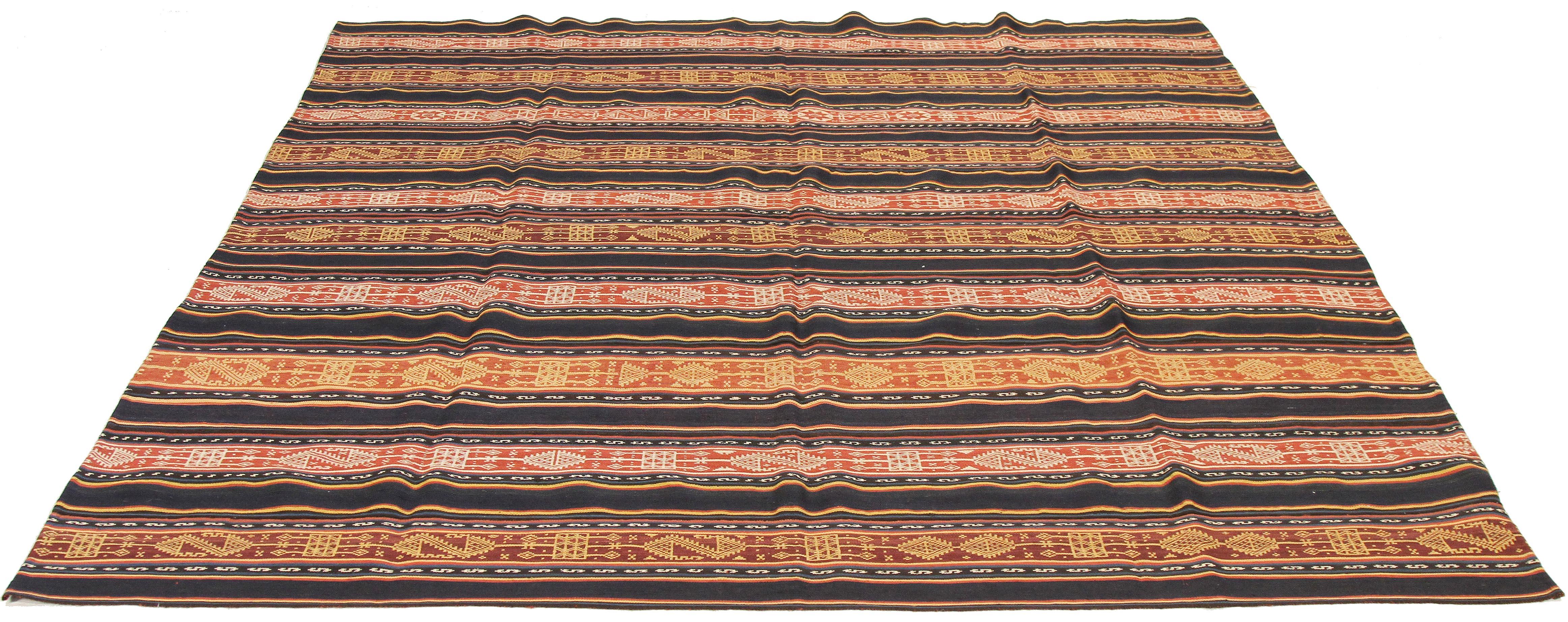 Antique Persian rug handwoven from the finest sheep’s wool and colored with all-natural vegetable dyes that are safe for humans and pets. It’s a traditional Jajim flat-weave design featuring tribal details on colored stripes. It’s a stunning piece