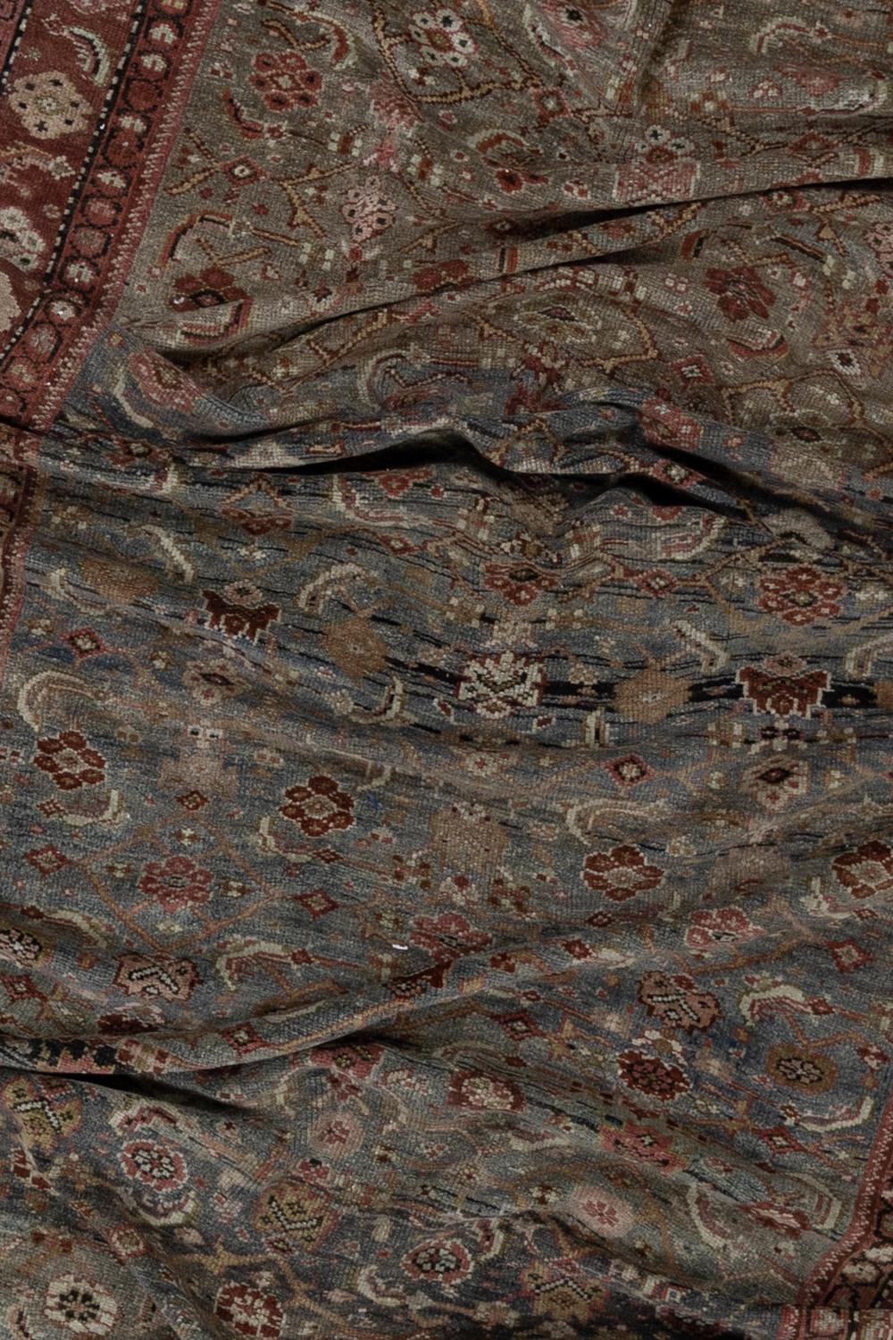 Age: late 19th century 

Colors: blue-gray, wine, olive, ivory

Pile: low-medium, soft underfoot

Wear Notes: 0

Material: wool on wool

Antique Persian gallery rug woven in the late 19th century. Excellent condition with lovely abrash.

Wear