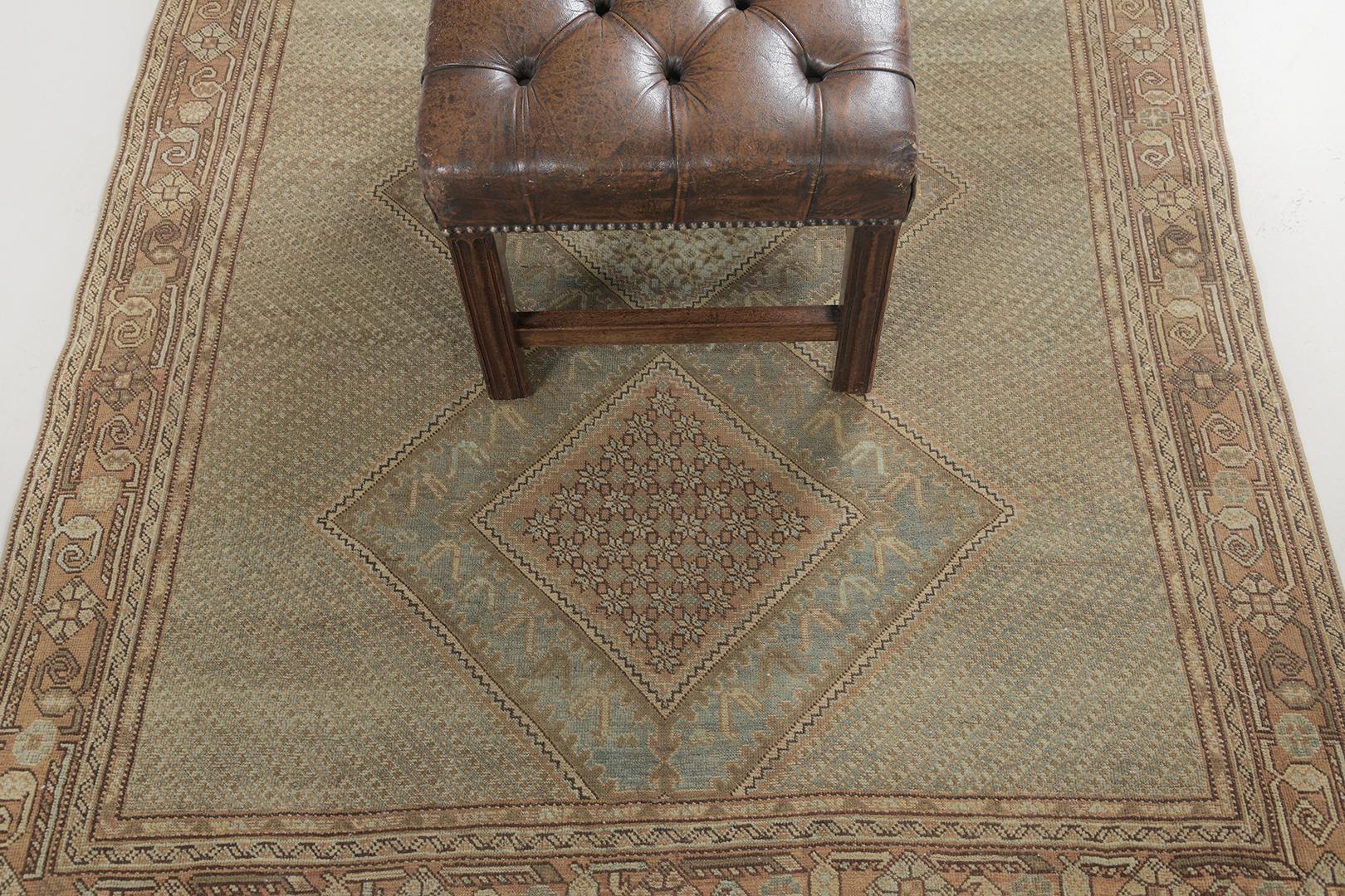 A stylishly luxurious hand-spun wool Ghasghaei Rug has immensely flexed its versatility in a series of bands along the perimeter of emblems. It is surrounded by different kinds of intricate symbols and geometric motifs. The earthy color scheme is