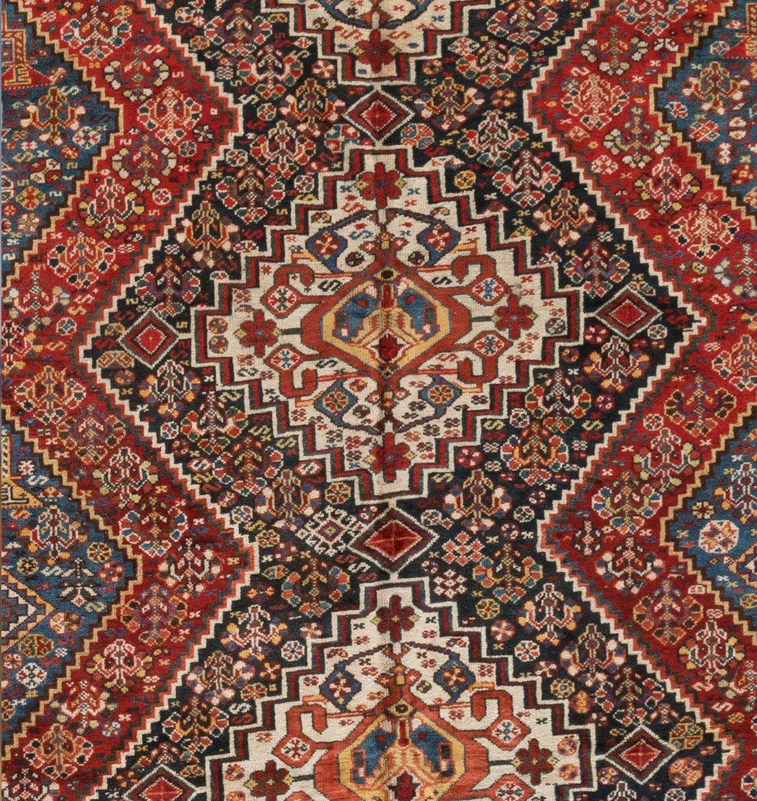 This lovely antique Persian Ghashgai navy geometric carpet measures 6.6 x 9.10 ft. and is from 1920s-1930s.

