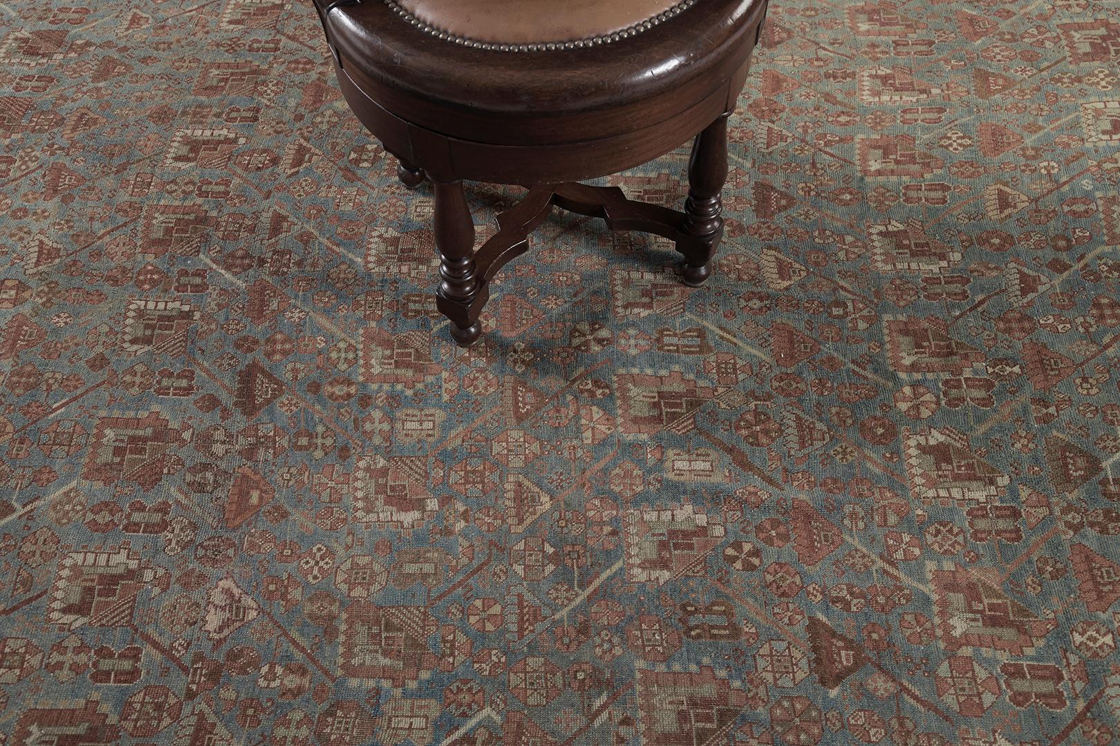 A fascinating antique Persian Ghashgaie rug that features timeless sophistication and nostalgic appeal. This enchanting rug is enclosed with a symbolical elements flanked with inner and outer guard bands. The abrashed turquoise ombre field is