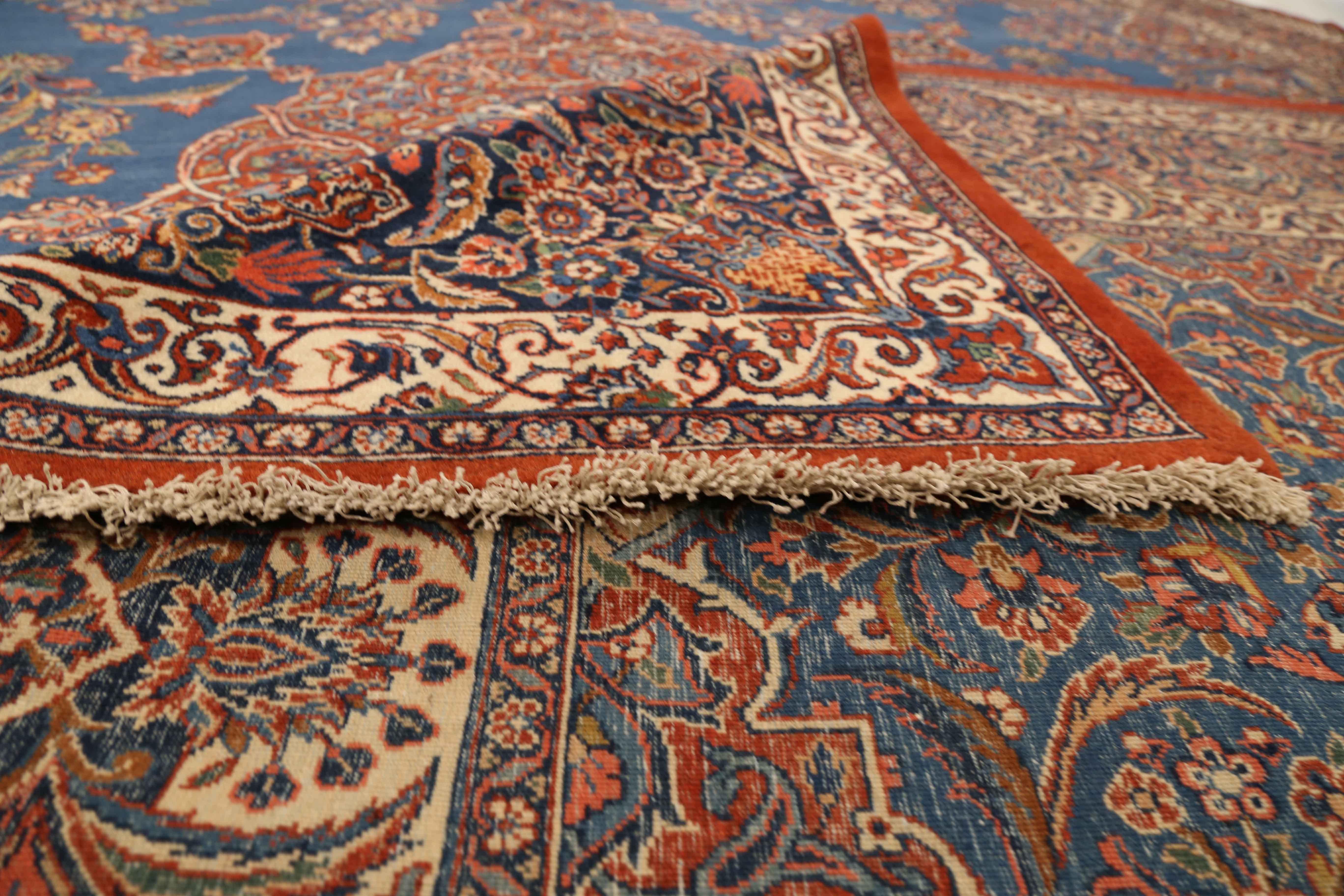1920s era antique Persian rug handmade with the highest quality of sheep wool and the richest blend of organic dyes in the Ghazvin region also known as Qazvin which was once the capital of the Safavid Empire. It features an elaborate floral