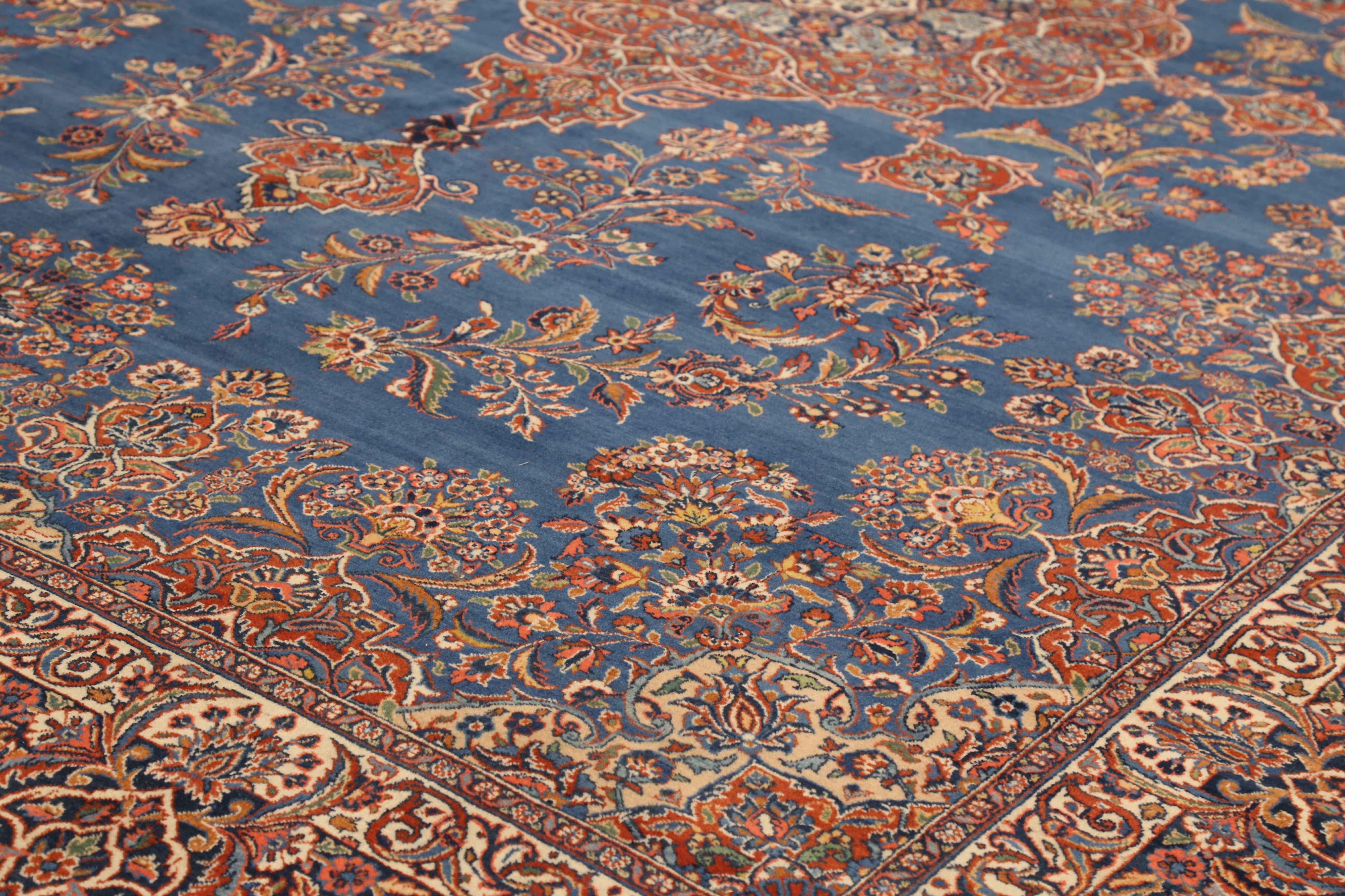 Hand-Knotted Antique Persian Ghazvin Rug with Flower Medallion over a Blue Field, circa 1920s For Sale