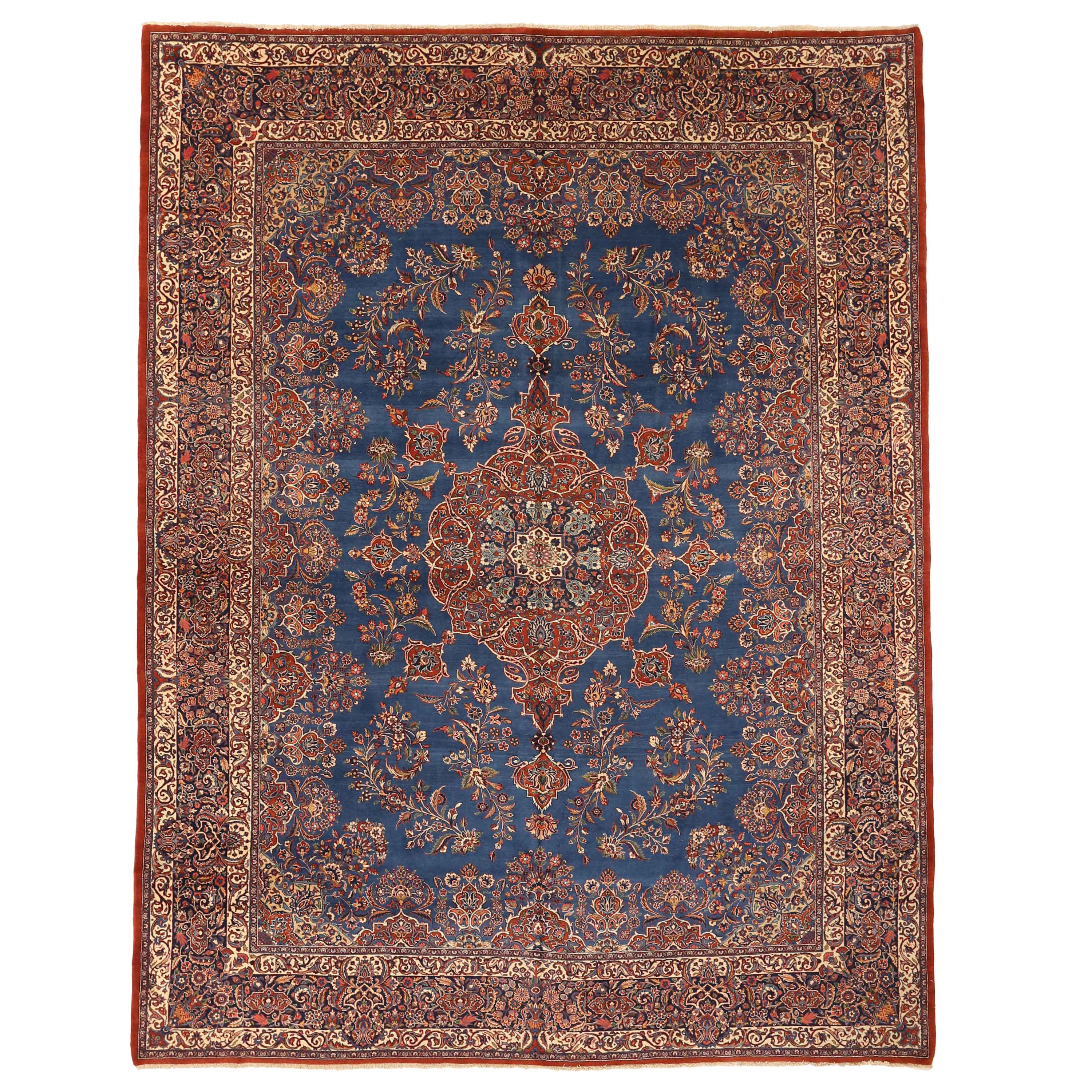 Antique Persian Ghazvin Rug with Flower Medallion over a Blue Field, circa 1920s For Sale