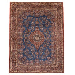 Antique Persian Ghazvin Rug with Flower Medallion over a Blue Field, circa 1920s