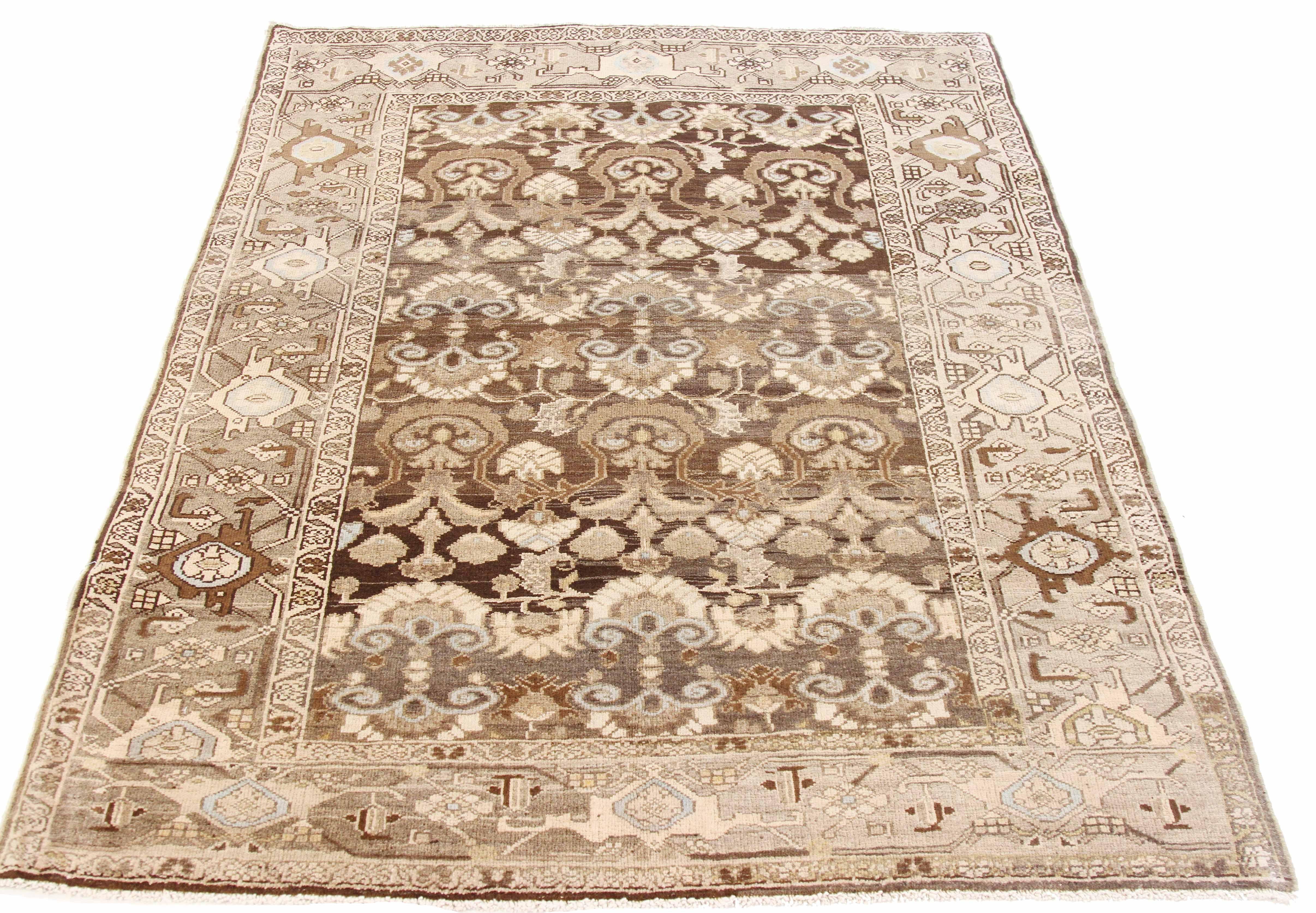 Antique Persian rug handwoven from the finest sheep’s wool and colored with all-natural vegetable dyes that are safe for humans and pets. It’s a traditional Gholtogh design featuring brown and beige botanical details on an ivory field. It’s a lovely