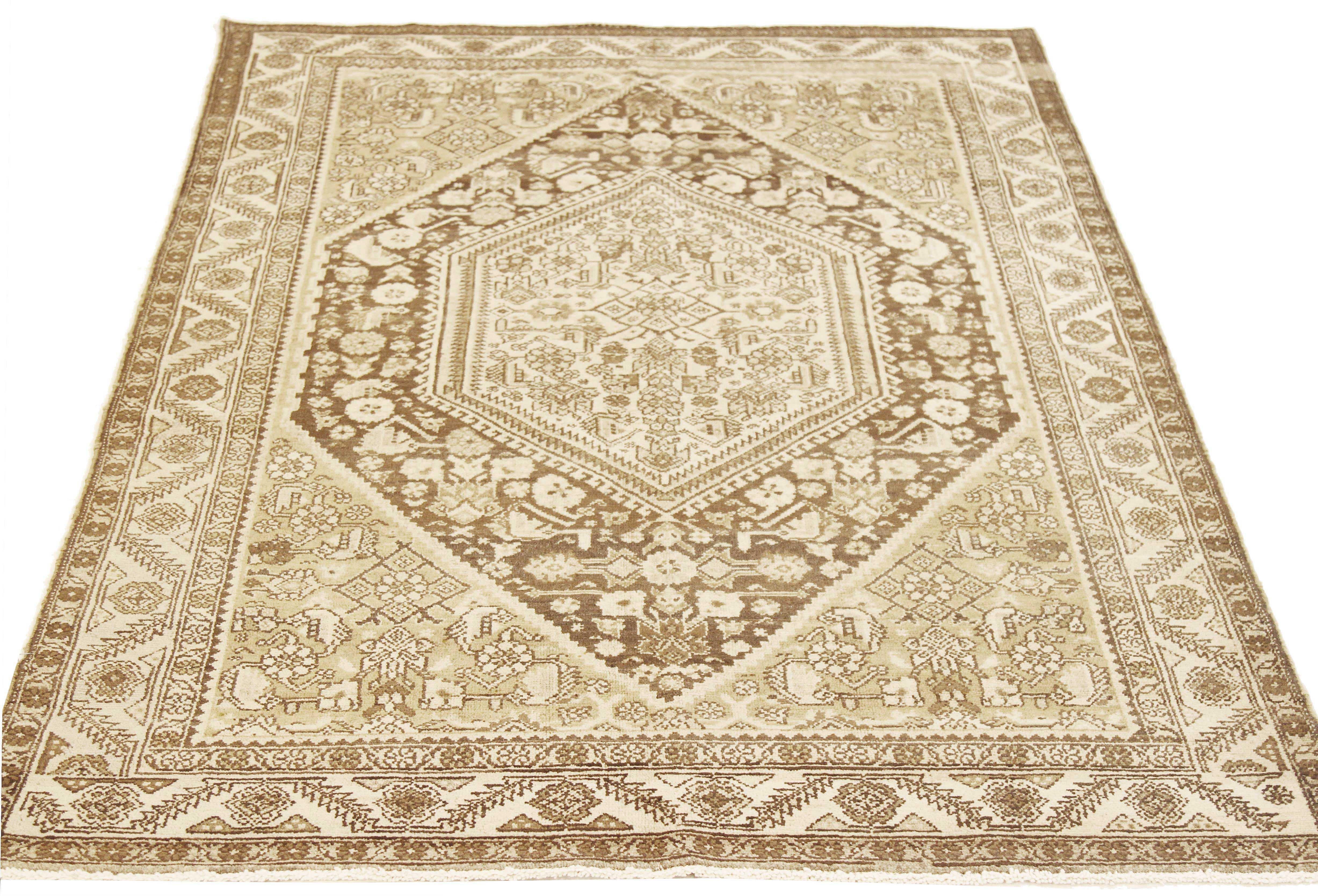 Antique Persian rug handwoven from the finest sheep’s wool and colored with all-natural vegetable dyes that are safe for humans and pets. It’s a traditional Gholtogh design featuring a brown central medallion on an ivory field. It’s a lovely piece