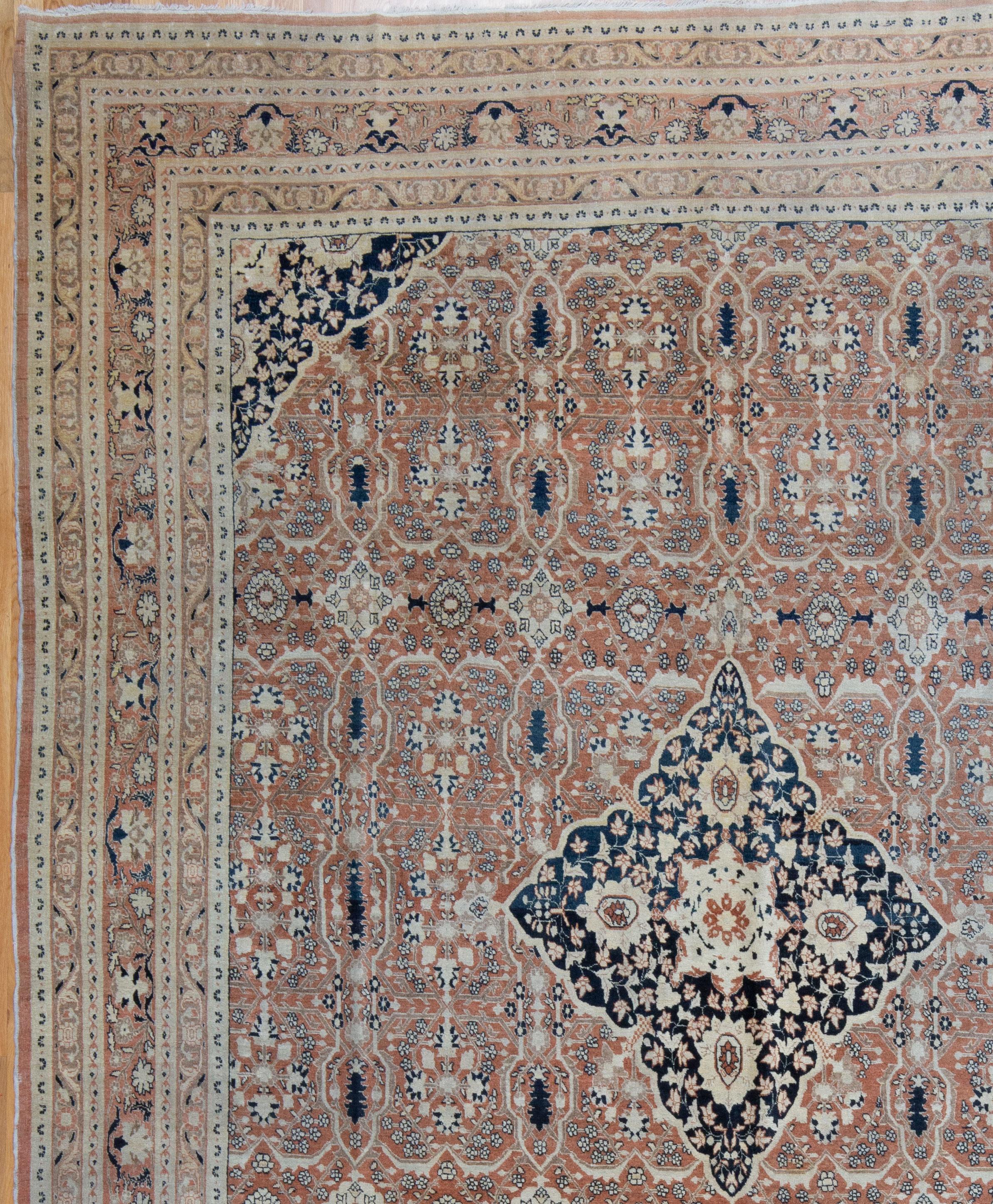 A high quality Tabriz with a fine weave and sophisticated design. Meandering flowers and vines on a blush pink field. Naturally dyed from the last quarter of the 19th Century. In beautiful condition with a low wool pile and preserved sides and ends.