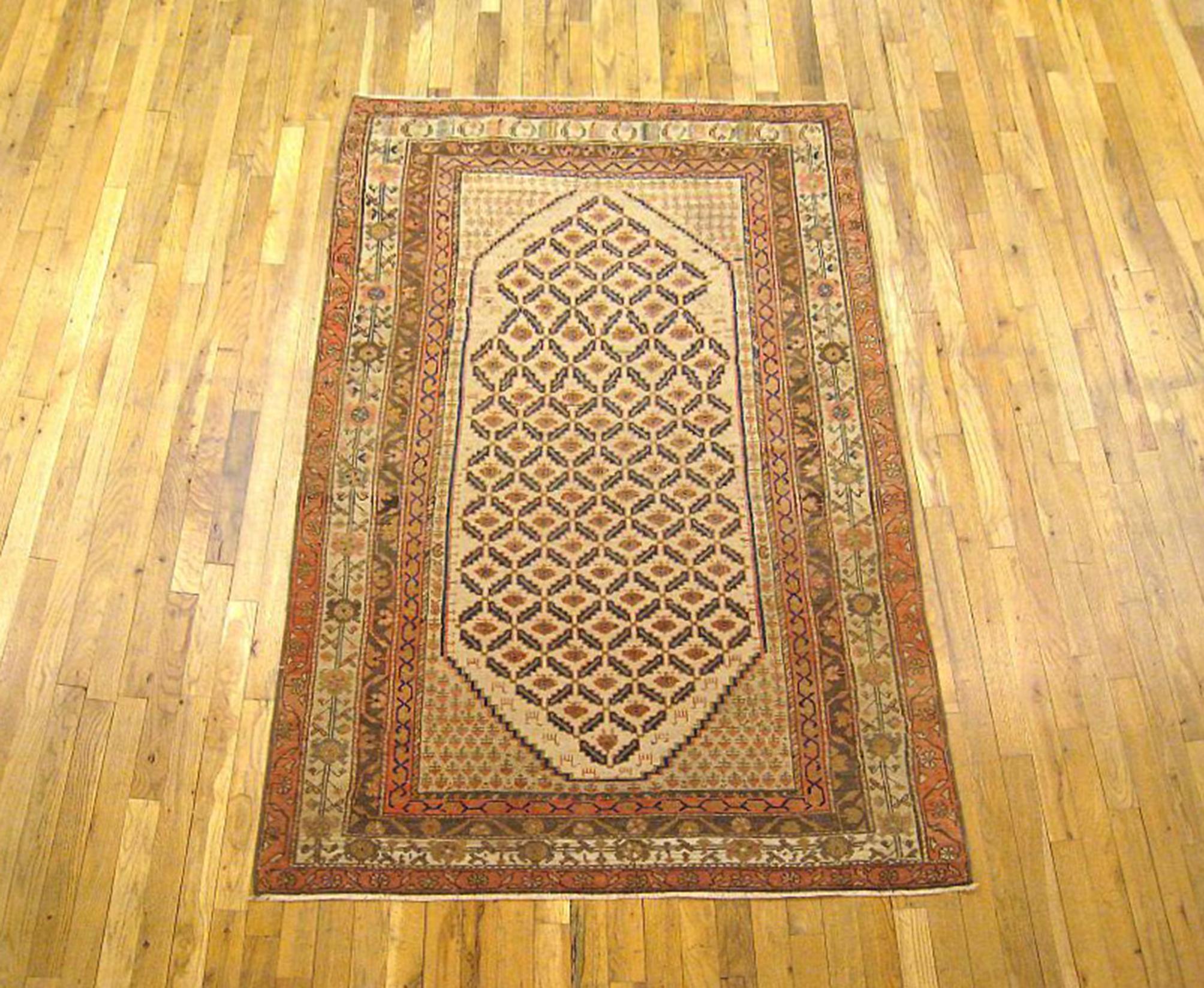 An antique Persian Hamadan Camel Hair oriental rug, size 6'3 x 4'0, circa 1920. This handsome hand-knotted wool carpet is uniquely sized and styled for a piece of this type, with a repeating diamond design in the central field, enclosed within