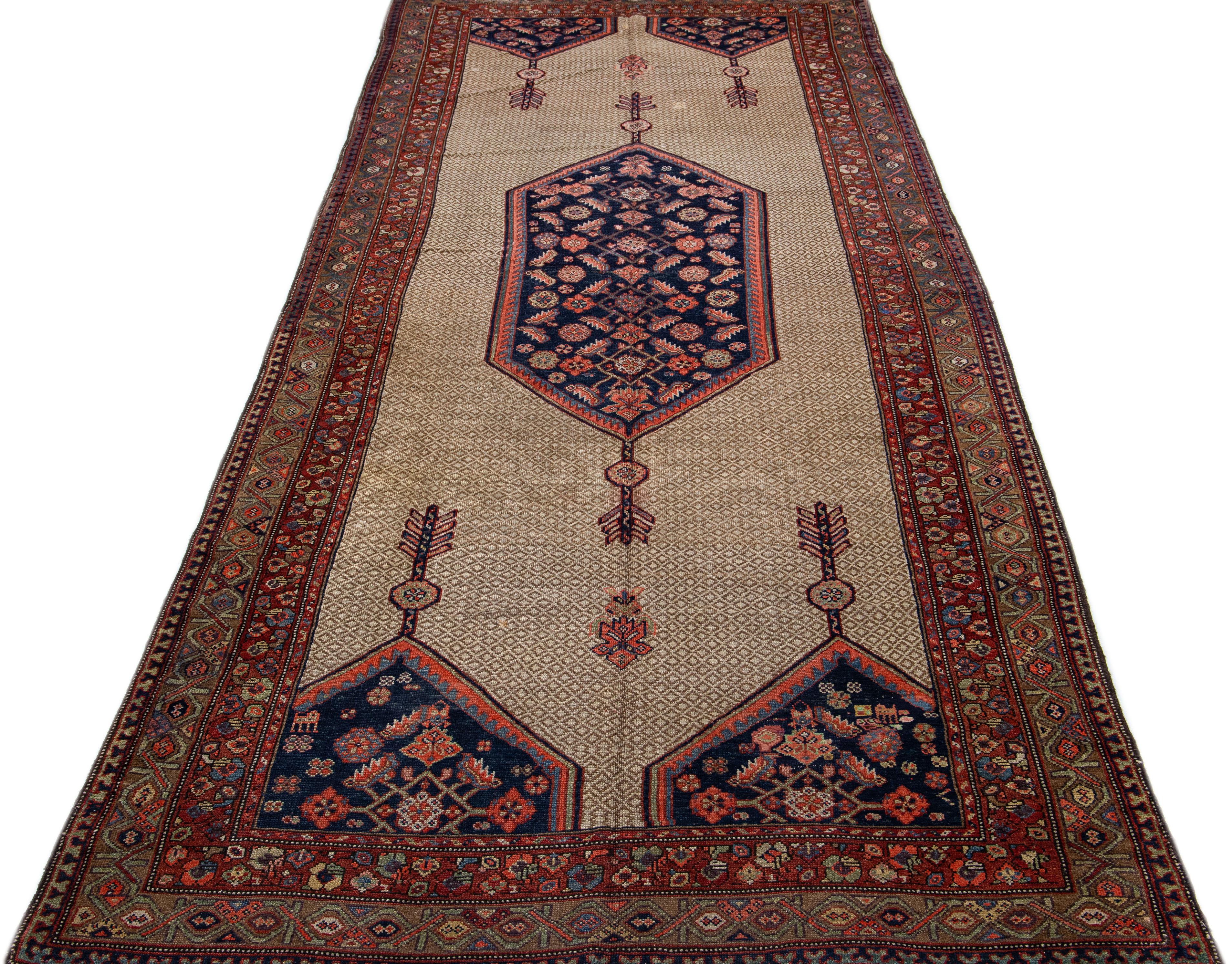 Beautiful antique Persian hand knotted wool rug with a beige color field. This piece has multicolor accents in a gorgeous blue medallion design.

This rug measures 5' 6' x 12' 9
