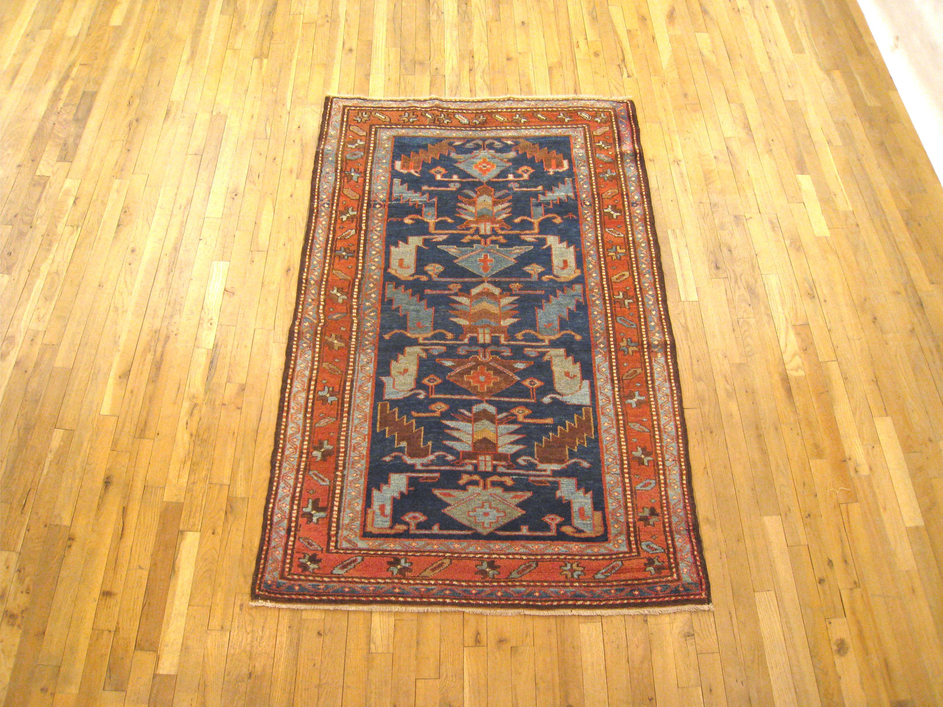 An antique Persian Hamadan oriental rug, size 6'2 x 4'0, circa 1920. This small, handwoven wool carpet features a large-scale geometric design in the blue central field, which is enclosed within several layers of unobtrusive outer borders. In