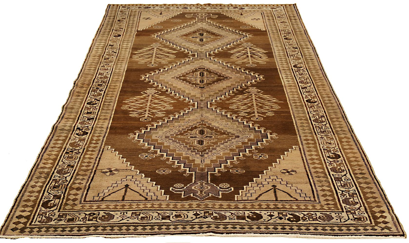 Antique Persian rug handwoven from the finest sheep’s wool and colored with all-natural vegetable dyes that are safe for humans and pets. It’s a traditional Hamedan design featuring floral patterns in brown and black on a mixed brown and beige