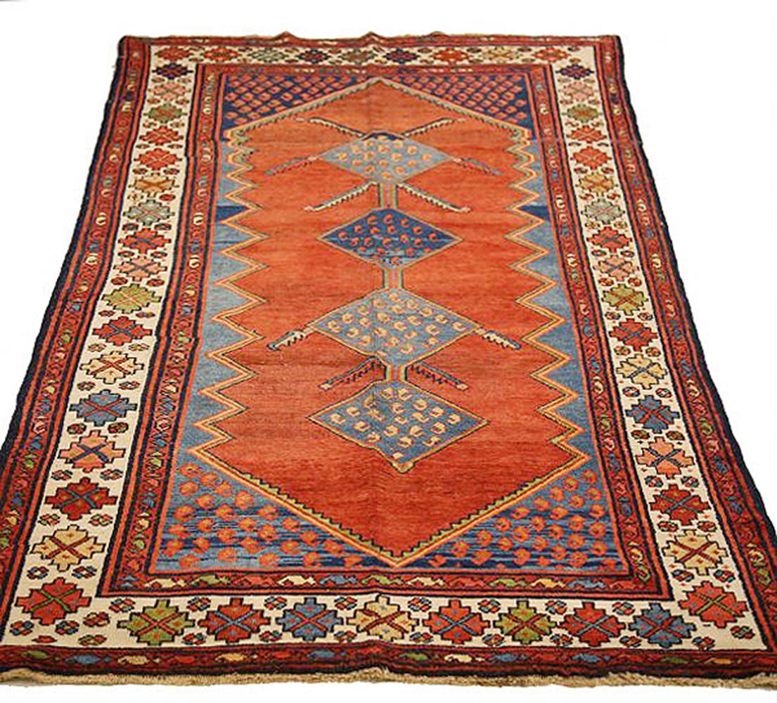 Antique Persian rug handwoven from the finest sheep’s wool and colored with all-natural vegetable dyes that are safe for humans and pets. It’s a traditional Hamedan design featuring floral patterns in bold colors of red and navy blue over a red and