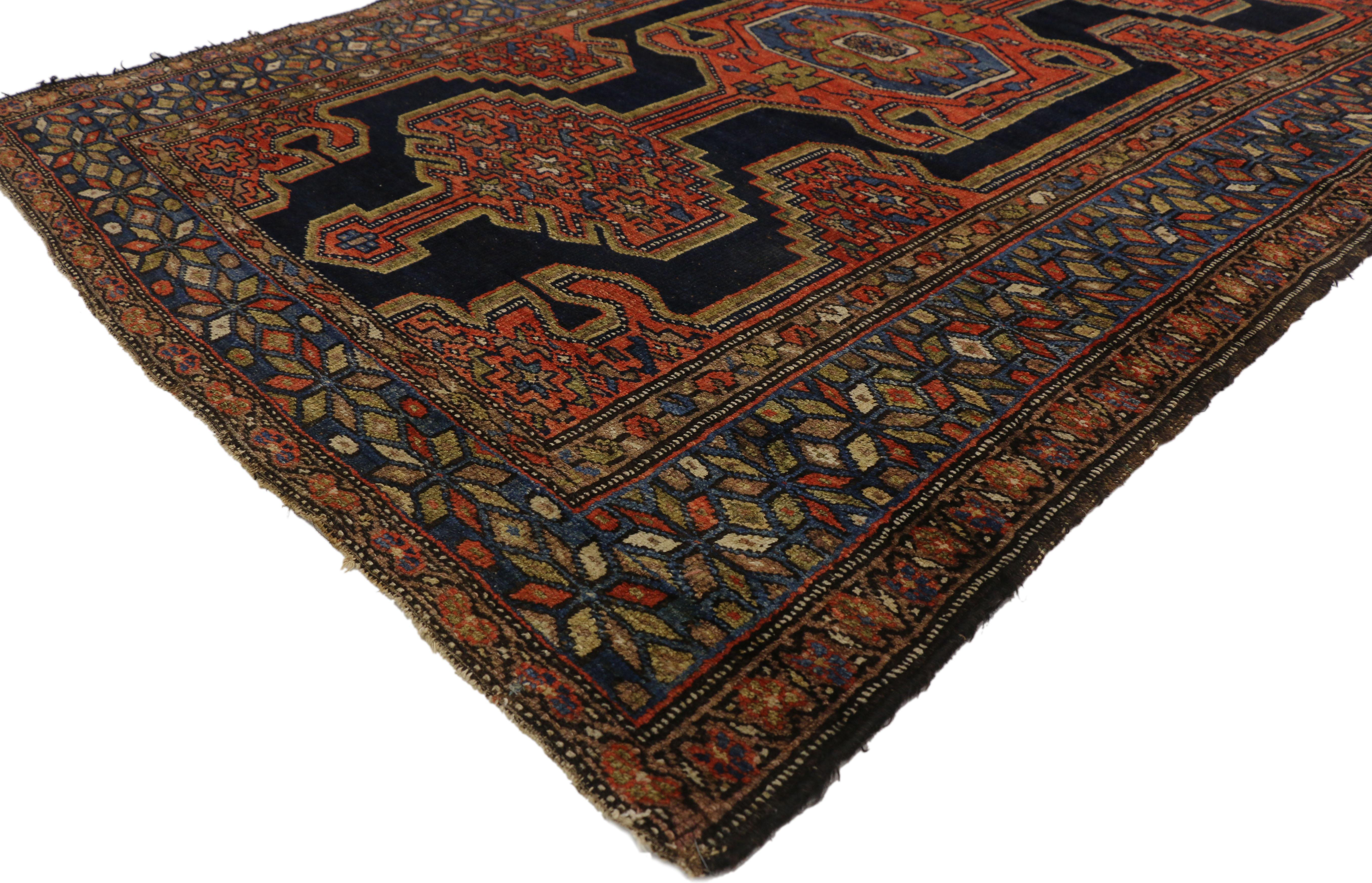 Full of character and stately presence, this antique Persian Hamadan rug with modern tribal style showcases an extravagant geometric design rendered in beautiful variegated shades of navy blue, red, brown and blue. Featuring intrinsic geometric