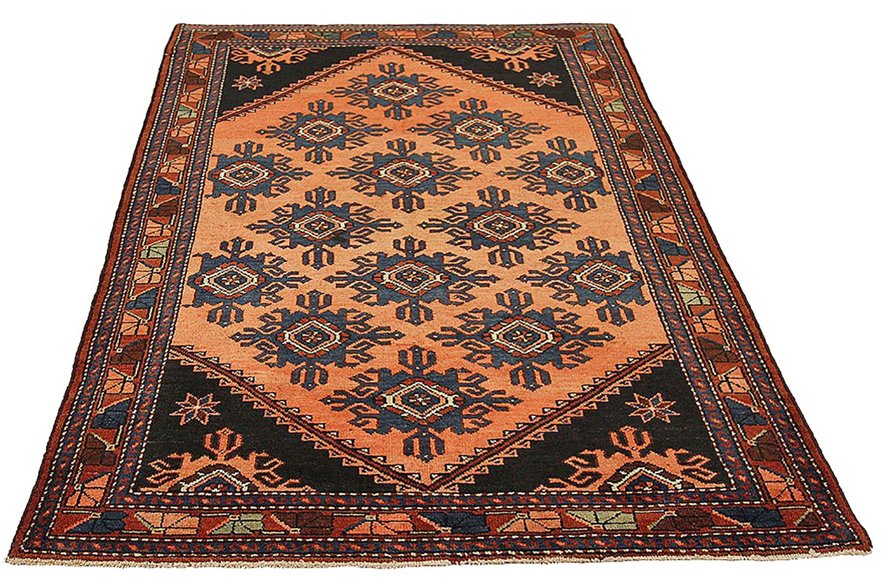 Antique Persian rug handwoven from the finest sheep’s wool and colored with all-natural vegetable dyes that are safe for humans and pets. It’s a traditional Hamedan design featuring floral patterns in bold colors of brown and navy over a black