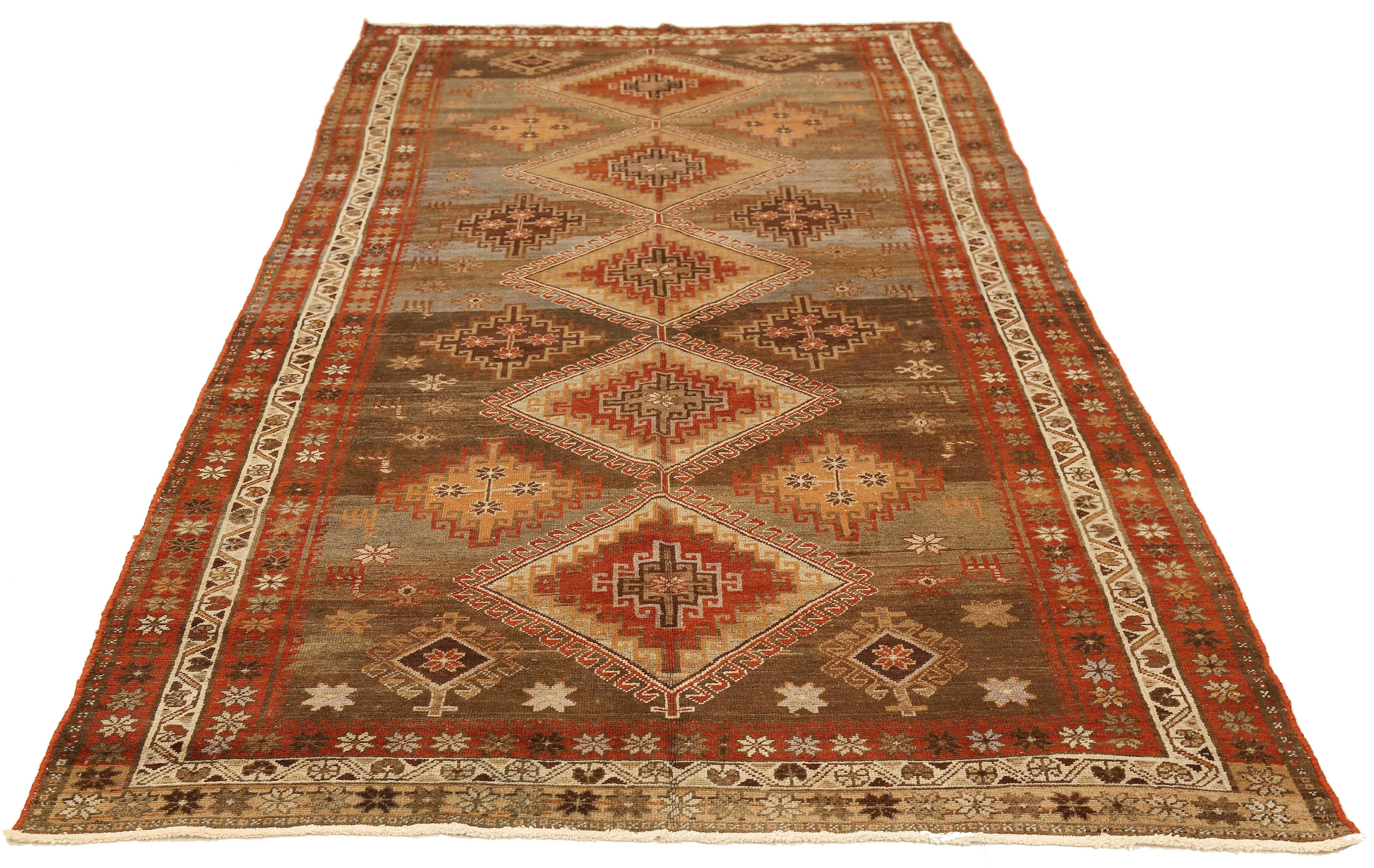 Antique Persian rug handwoven from the finest sheep’s wool and colored with all-natural vegetable dyes that are safe for humans and pets. It’s a traditional Hamedan design featuring tribal patterns in red, brown and beige. The details are often