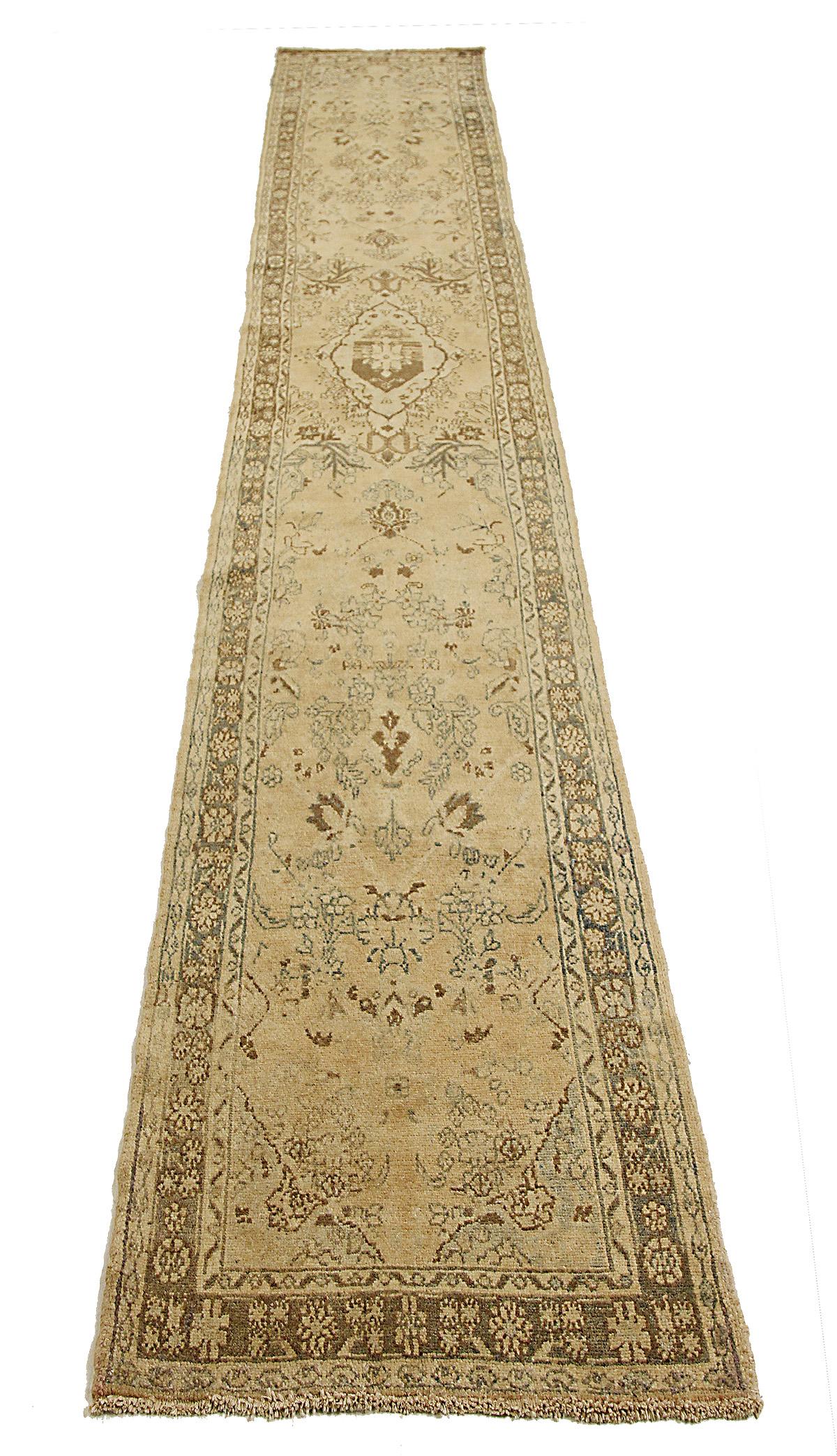 Antique Persian runner rug handwoven from the finest sheep’s wool and colored with all-natural vegetable dyes that are safe for humans and pets. It’s a traditional Hamadan design featuring floral patterns in brown and ivory over a beige field. The