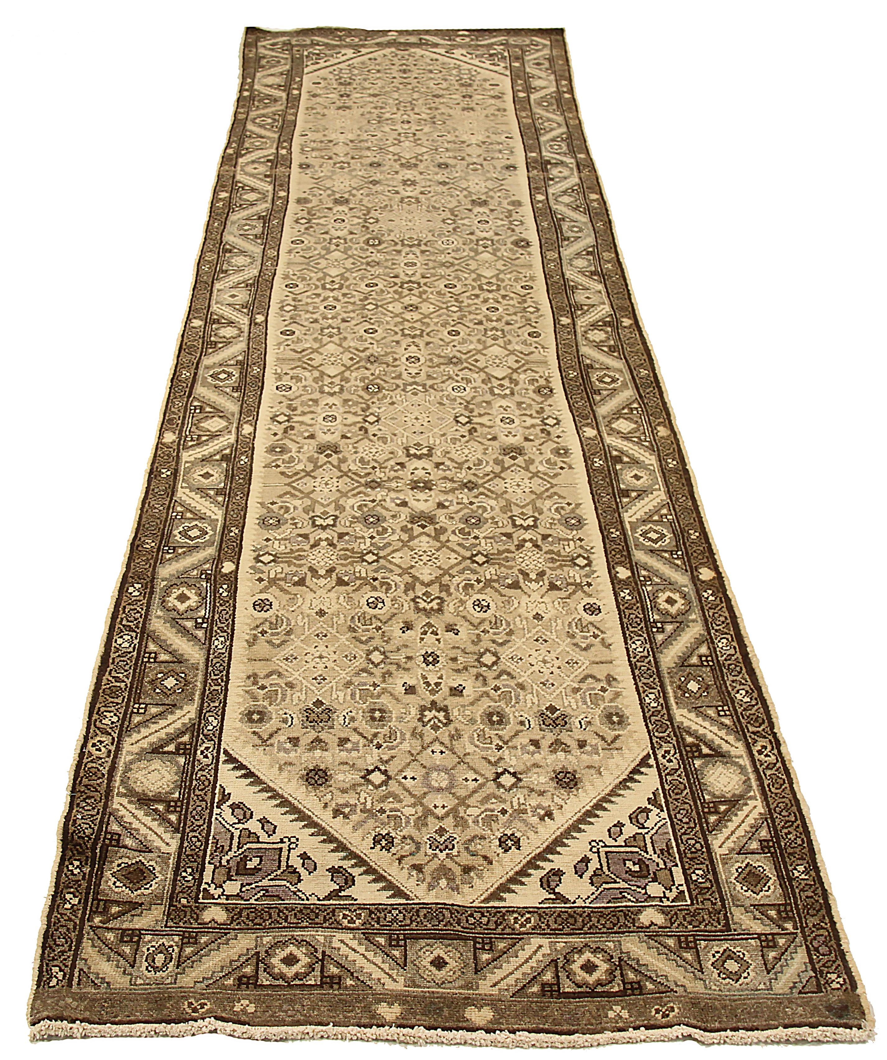 Antique Persian runner rug handwoven from the finest sheep’s wool and colored with all-natural vegetable dyes that are safe for humans and pets. It’s a traditional Hamadan design featuring geometric and floral details on an ivory field. It’s a