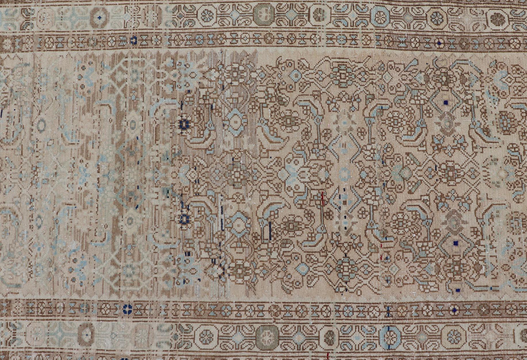 Measures: 3'3 x 9'0 

This antique Persian Hamadan features a light neutral palette with light blue accents. The field and border share a light cream-camel color with accents of light blue, olive, taupe, and cream. The design is very detailed,