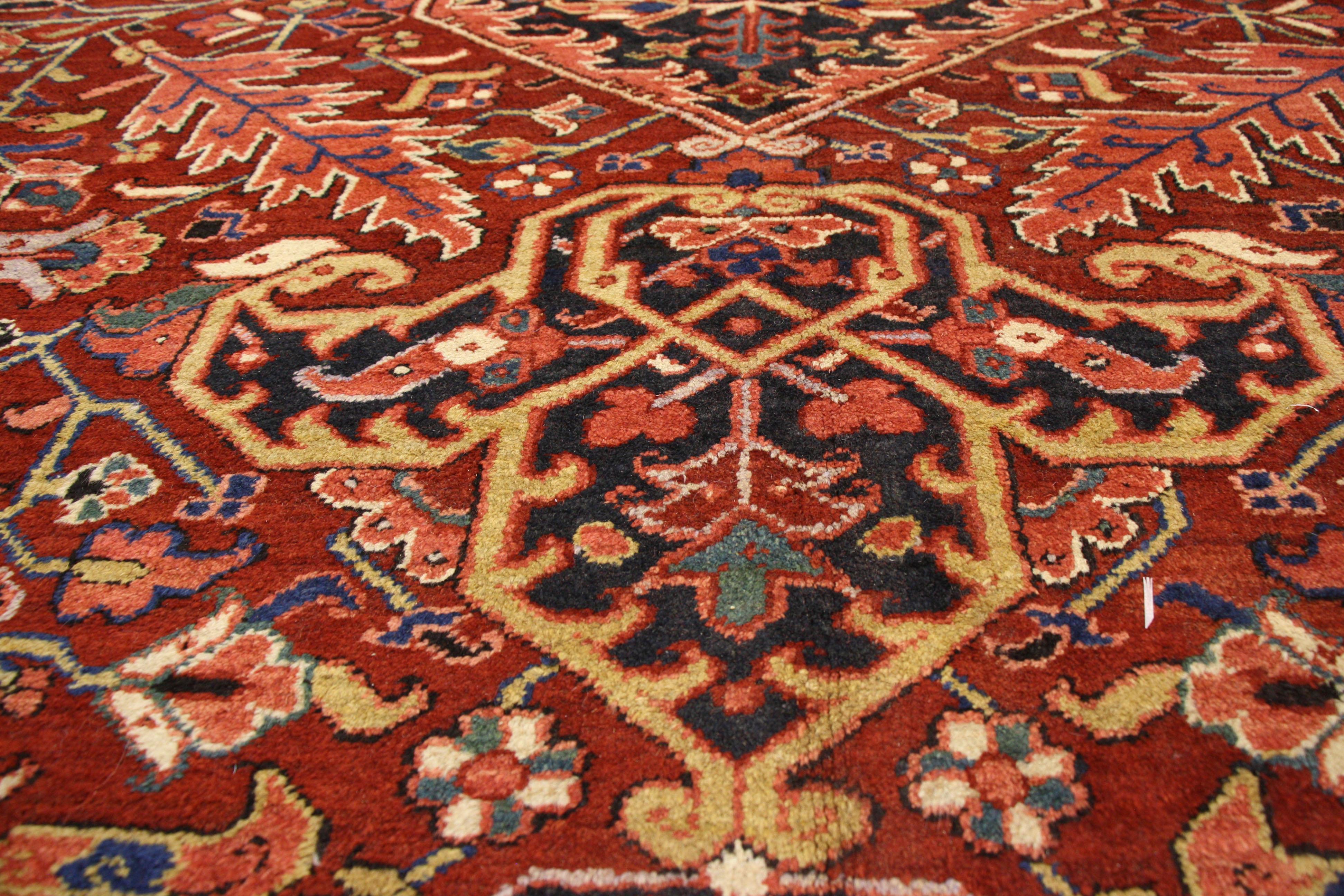 77174 Antique Heriz Persian Palace Size Rug with English Turdor Manor Style. Traditional and regal with brilliant color, this antique Persian Heriz palace size rug is comprised of a prominent central lozenge medallion flanked with two cartouche
