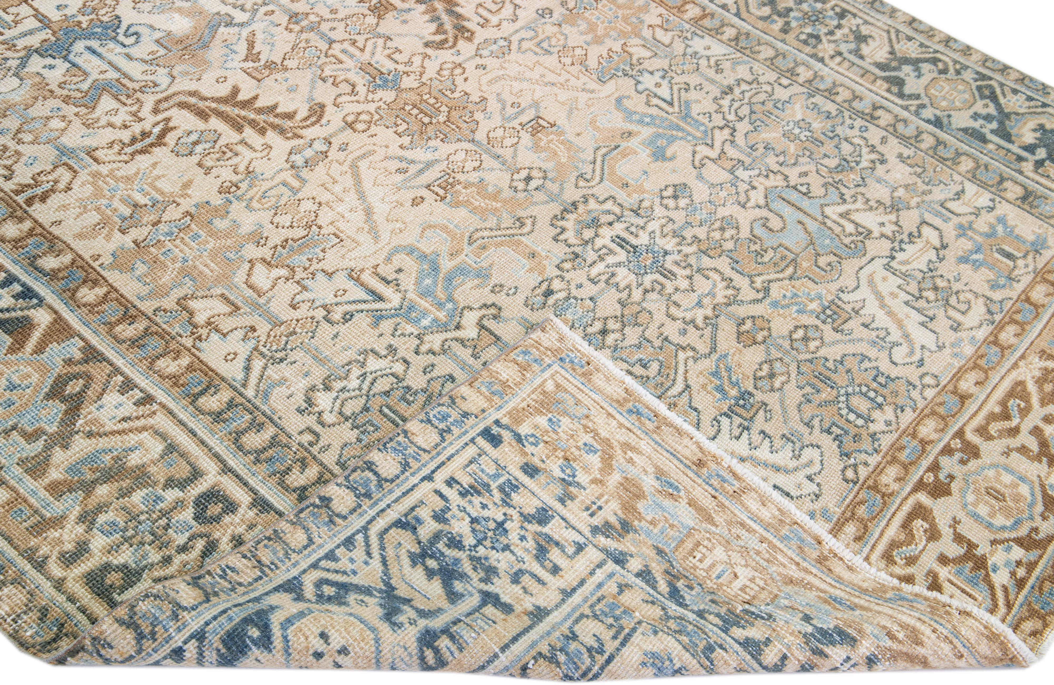 Beautiful antique Heriz hand-knotted wool rug with a beige color field. This Persian rug has a blue frame and accents in a gorgeous all-over geometric floral design.

This rug measures: 7' x 8'9