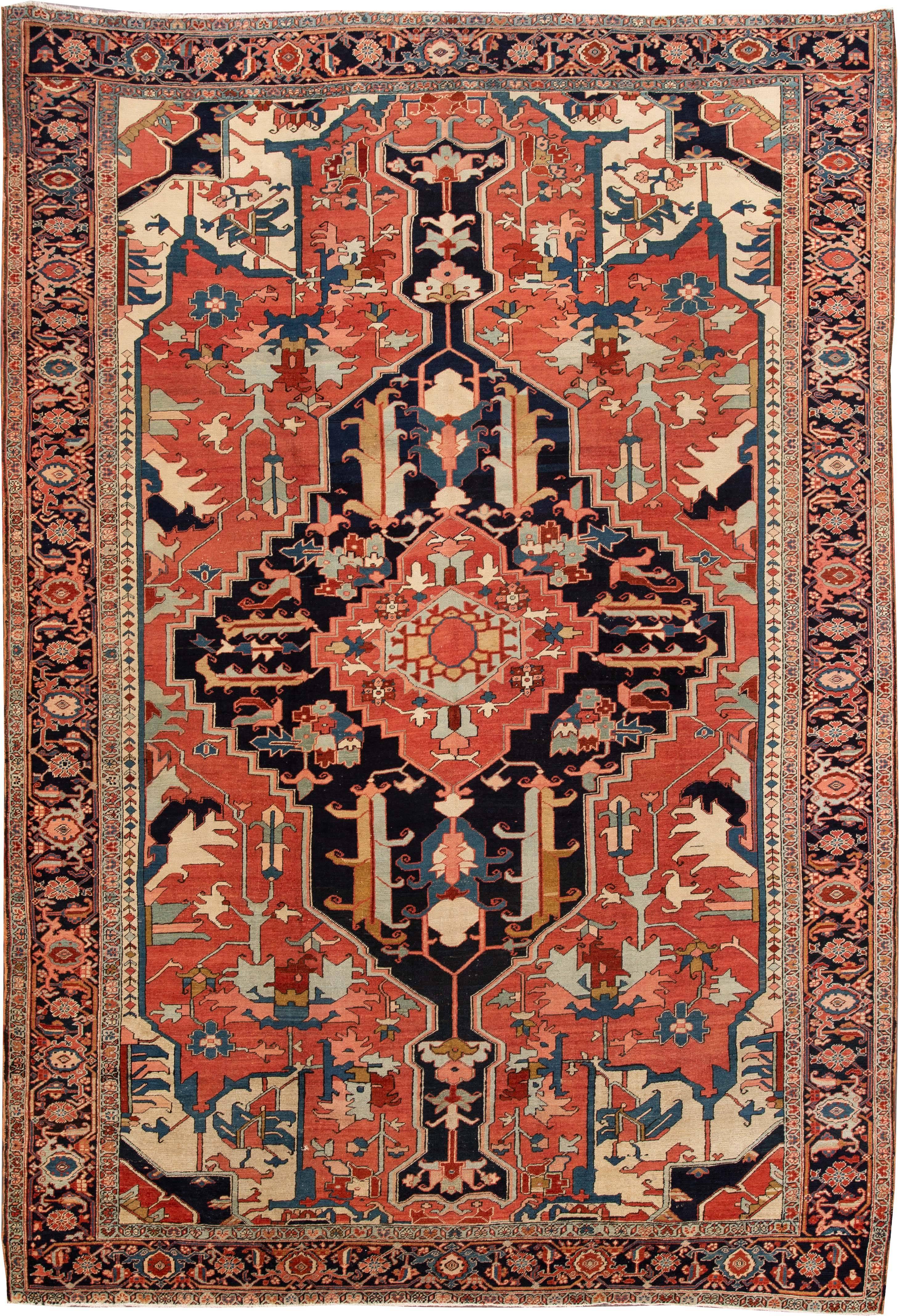 19th century (1880s) Persian Heriz rug with a rust field and traditional design in blue and cream. Measures approximately 9 feet by 13 feet. 