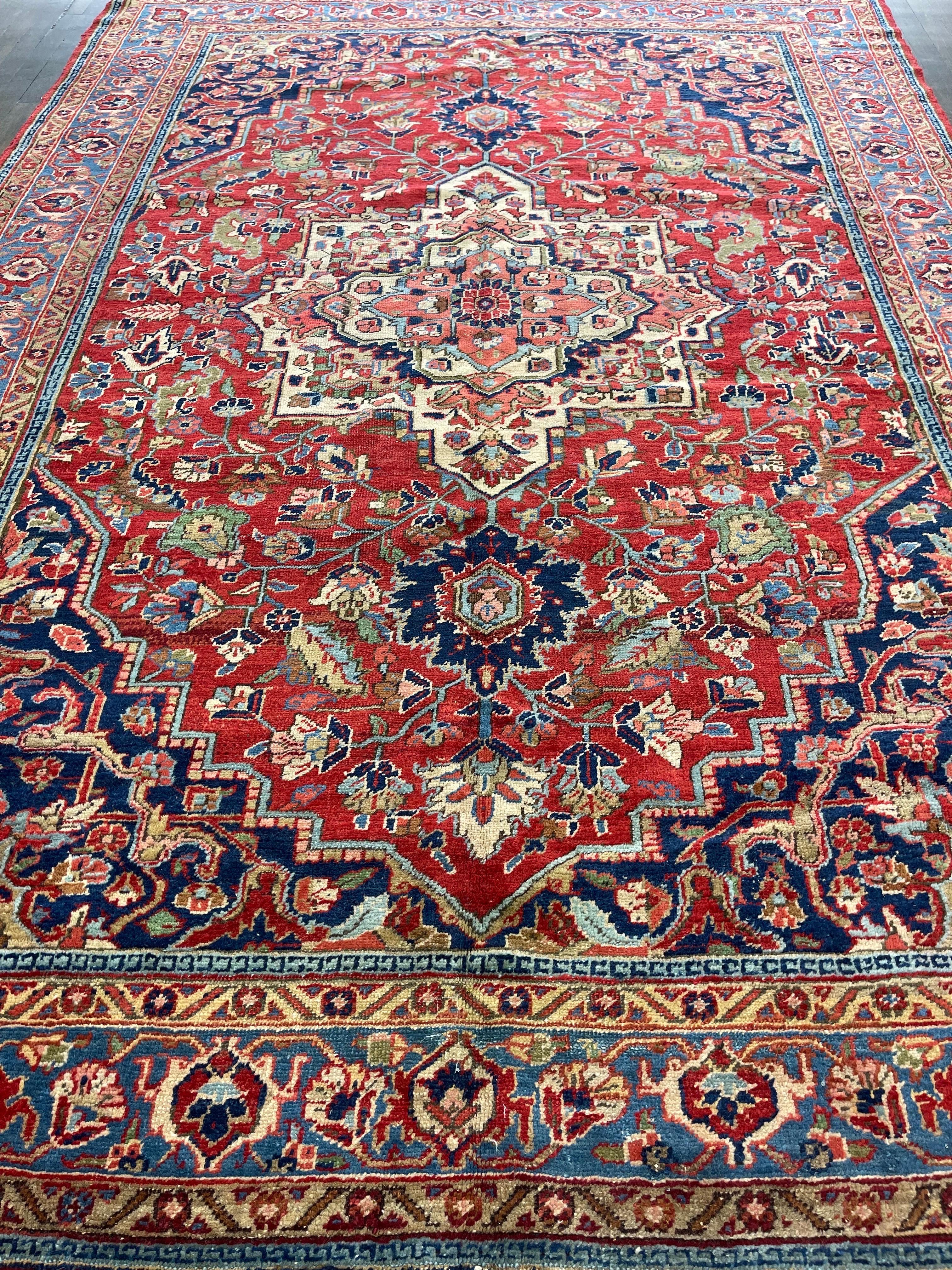 Here is an attractive Persian antique Heriz with a tomato red field decorated by a center medallion and framed with a sky blue border.The moth shade guard borders are a notable feature in this rug. The cute size of the rug is a rarity in Heriz group