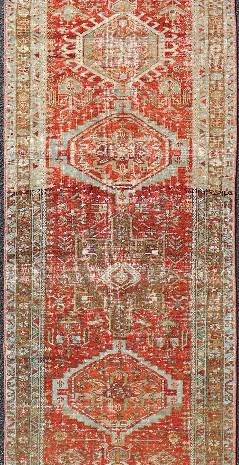Hand-Knotted Antique Persian Heriz Distressed Runner with Geometric Medallions in Soft Colors For Sale