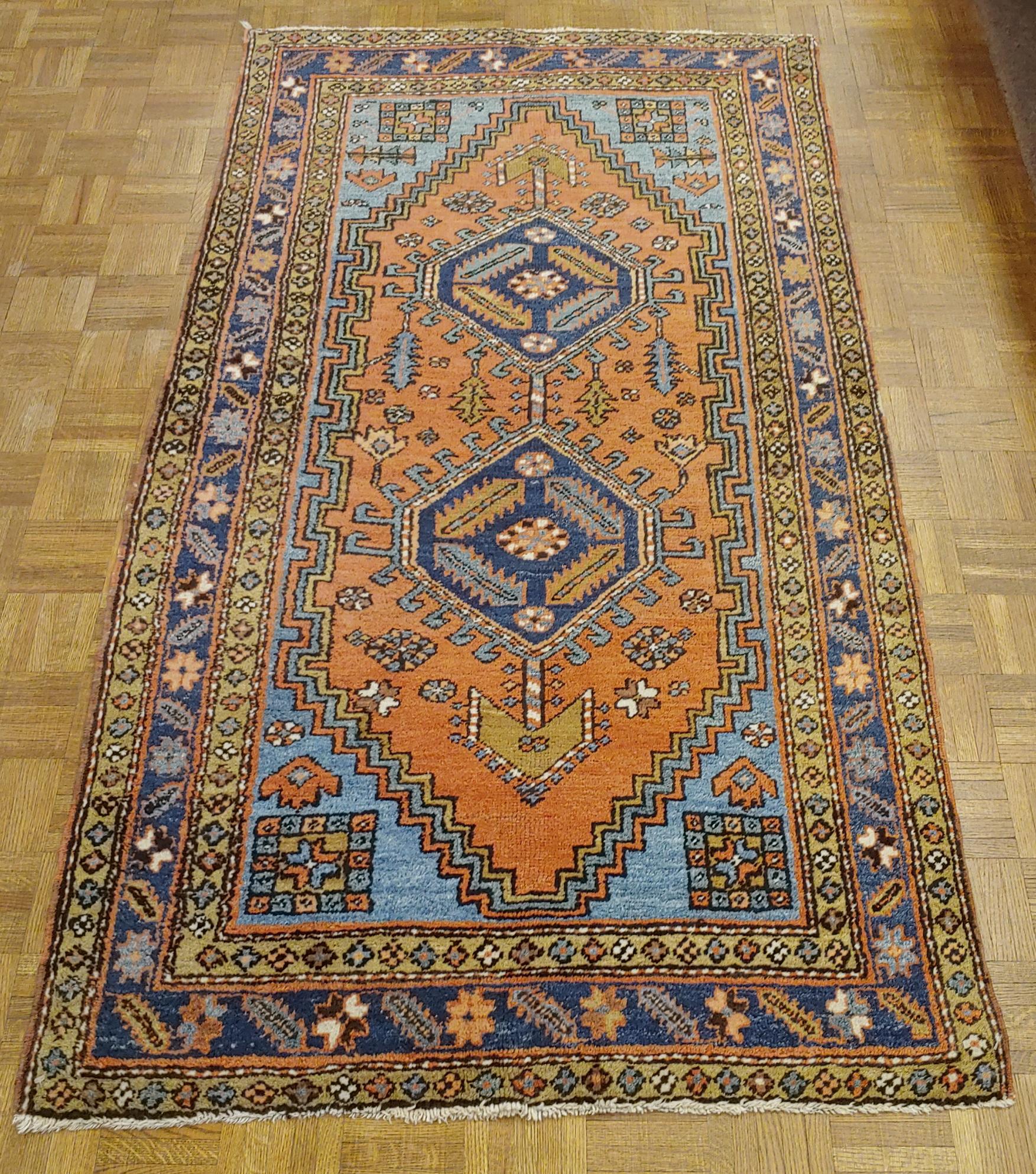 This is a great example of a scatter size Persian Heriz. Small Heriz rugs are very hard to find. This rug is 3-4 x 6-3 and is in wonderful condition. It has a rust field with two distinctive diamond shaped medallions and beautiful light blue