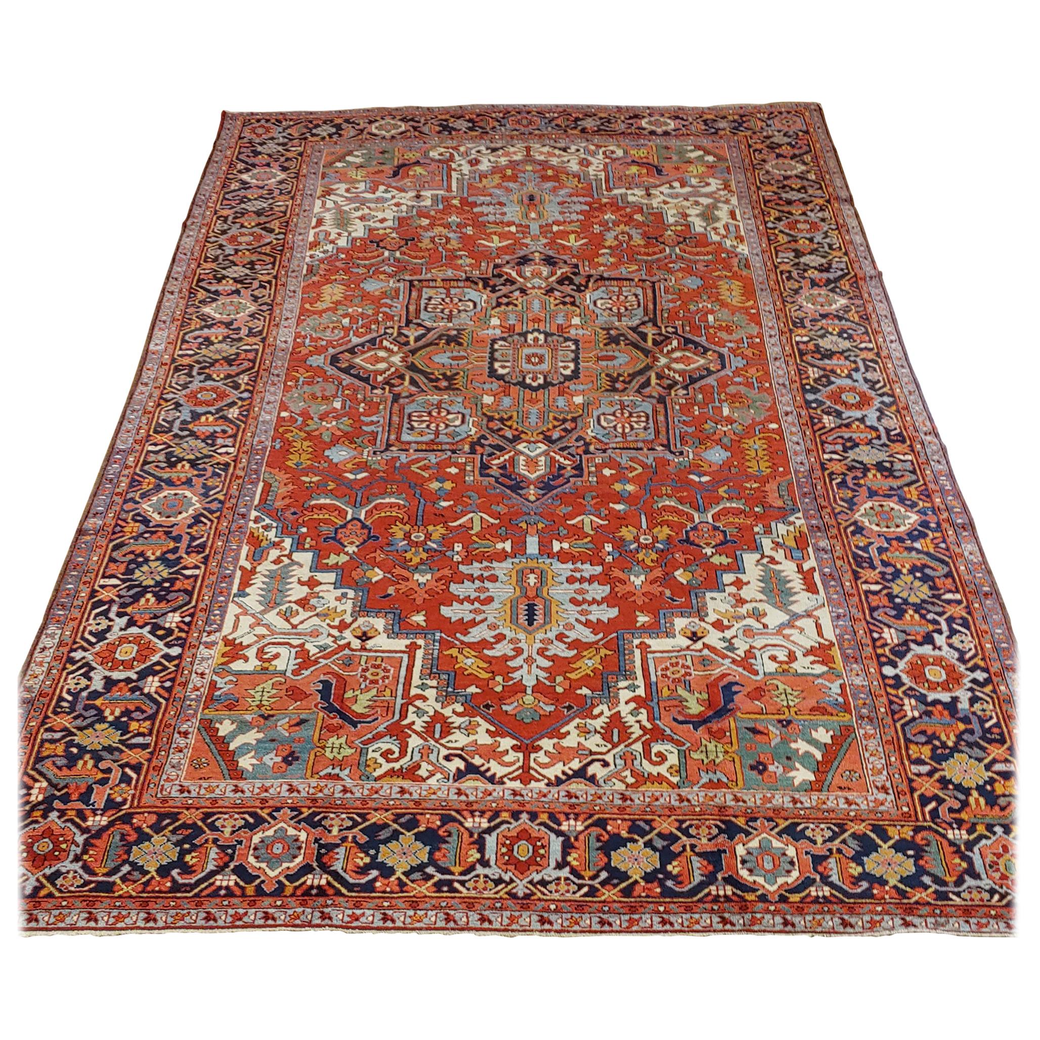 This is a gracious and beautiful Persian Heriz (though lots of dealers would call it a Serapi). The field is rust with ivory spandrels and a wonderful Herati motif border with navy background. The design also uses lots of light blue and a teal