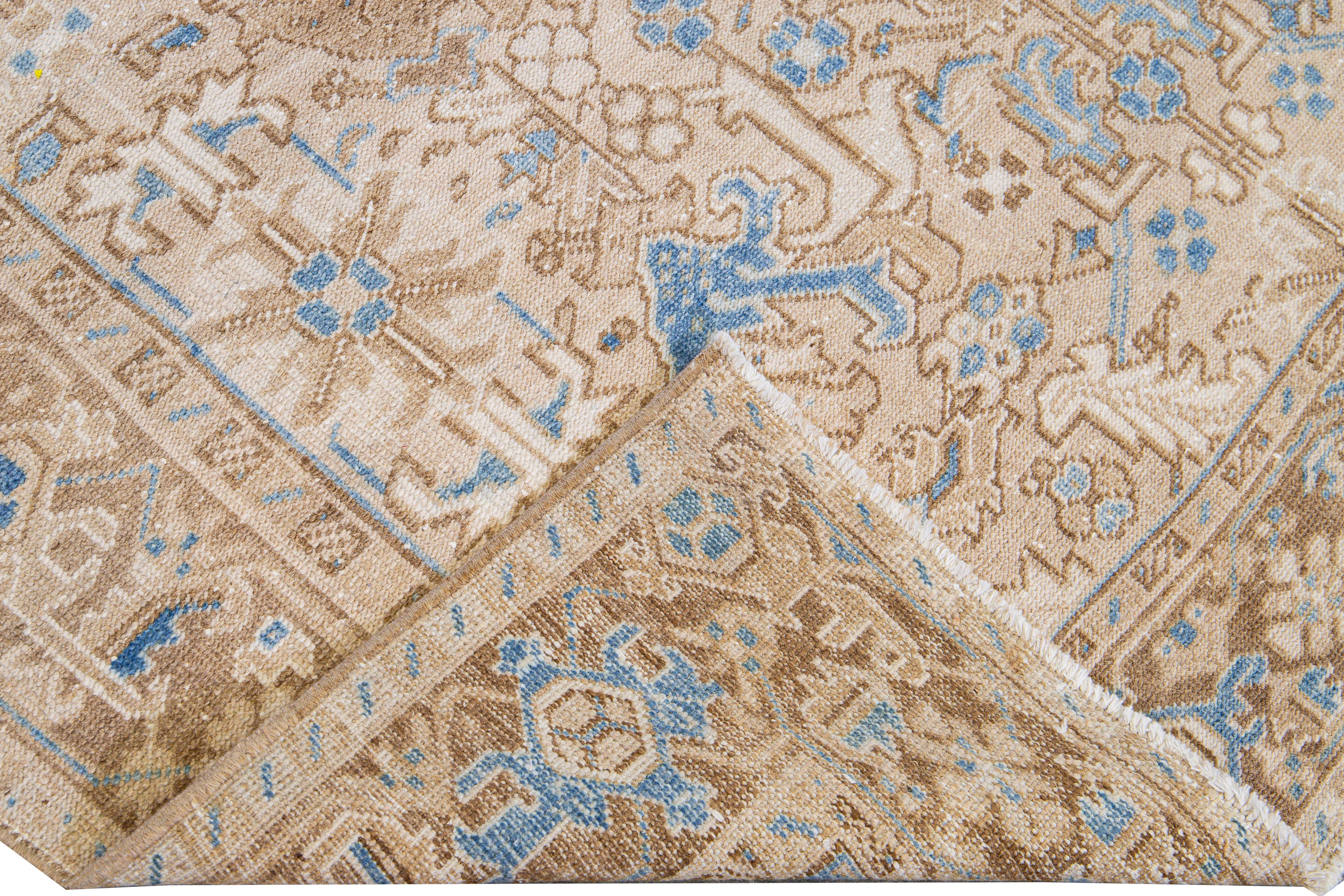 Beautiful antique Heriz hand-knotted wool rug with a beige field. This Persian rug has a blue and brown accent that featuring an all-over geometric floral pattern design.

This rug measures: 6'8