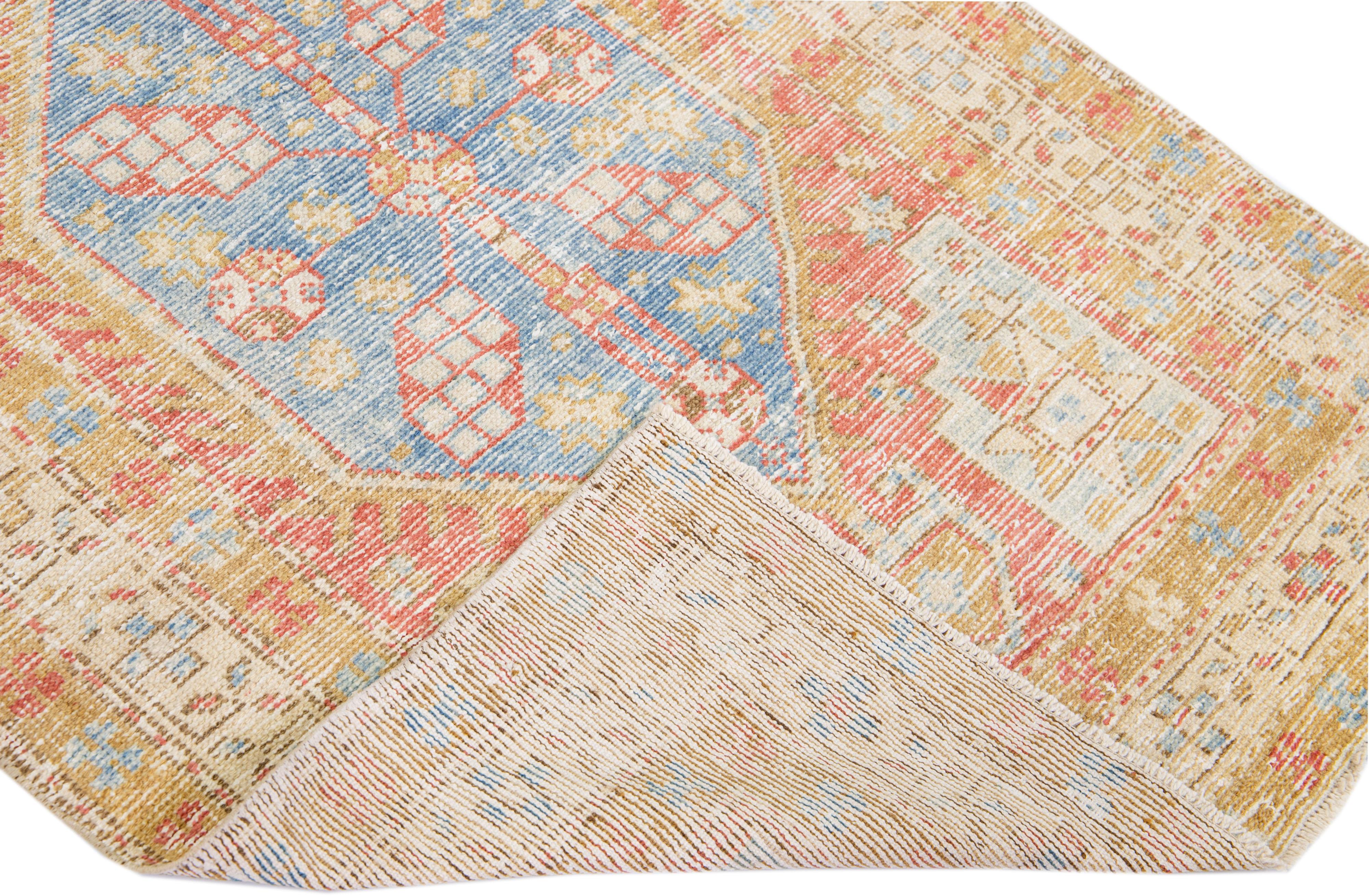 Beautiful antique Heriz hand-knotted wool runner with a red and blue field. This Persian rug has tan and beige accents in a gorgeous geometric medallion pattern.

This rug measures: 3'3