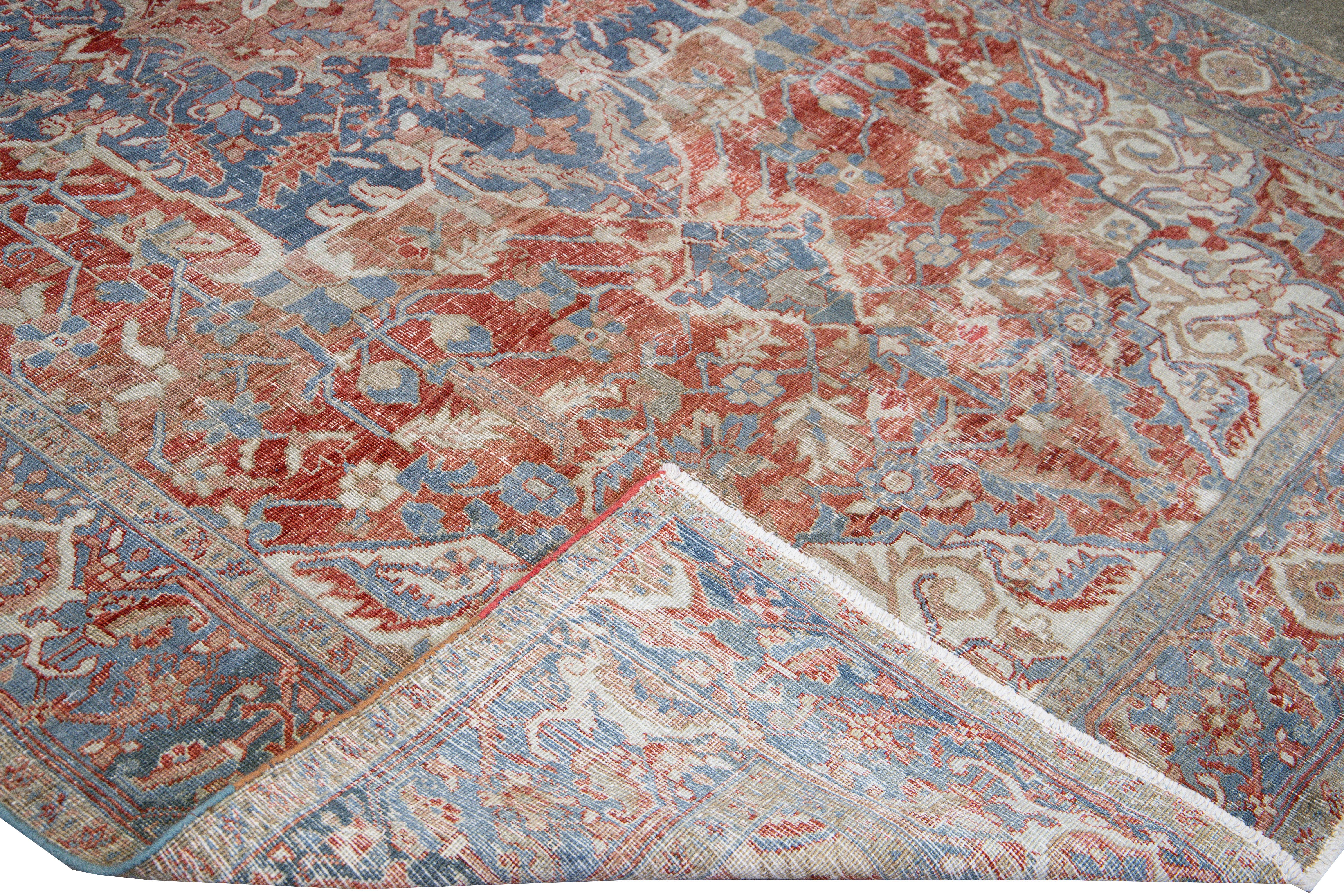 Beautiful antique Persian Heriz hand-knotted wool rug with a red field. This Serapi rug has a navy-blue frame and ivory accents in an all-over gorgeous shabby chic design.

This rug measures: 7'3