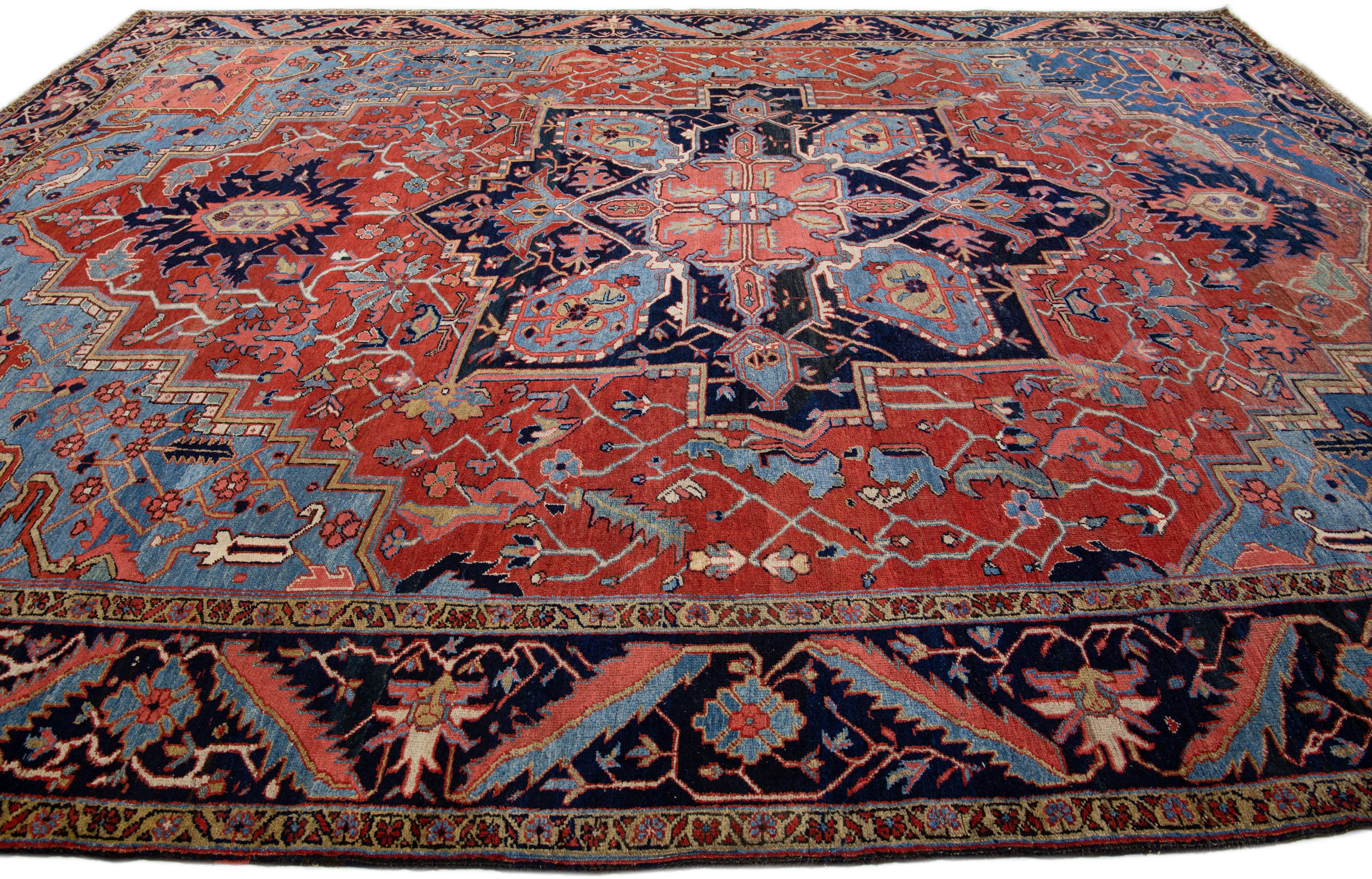 20th Century Antique Persian Heriz Handmade Red & Blue Wool Rug with Medallion Design For Sale