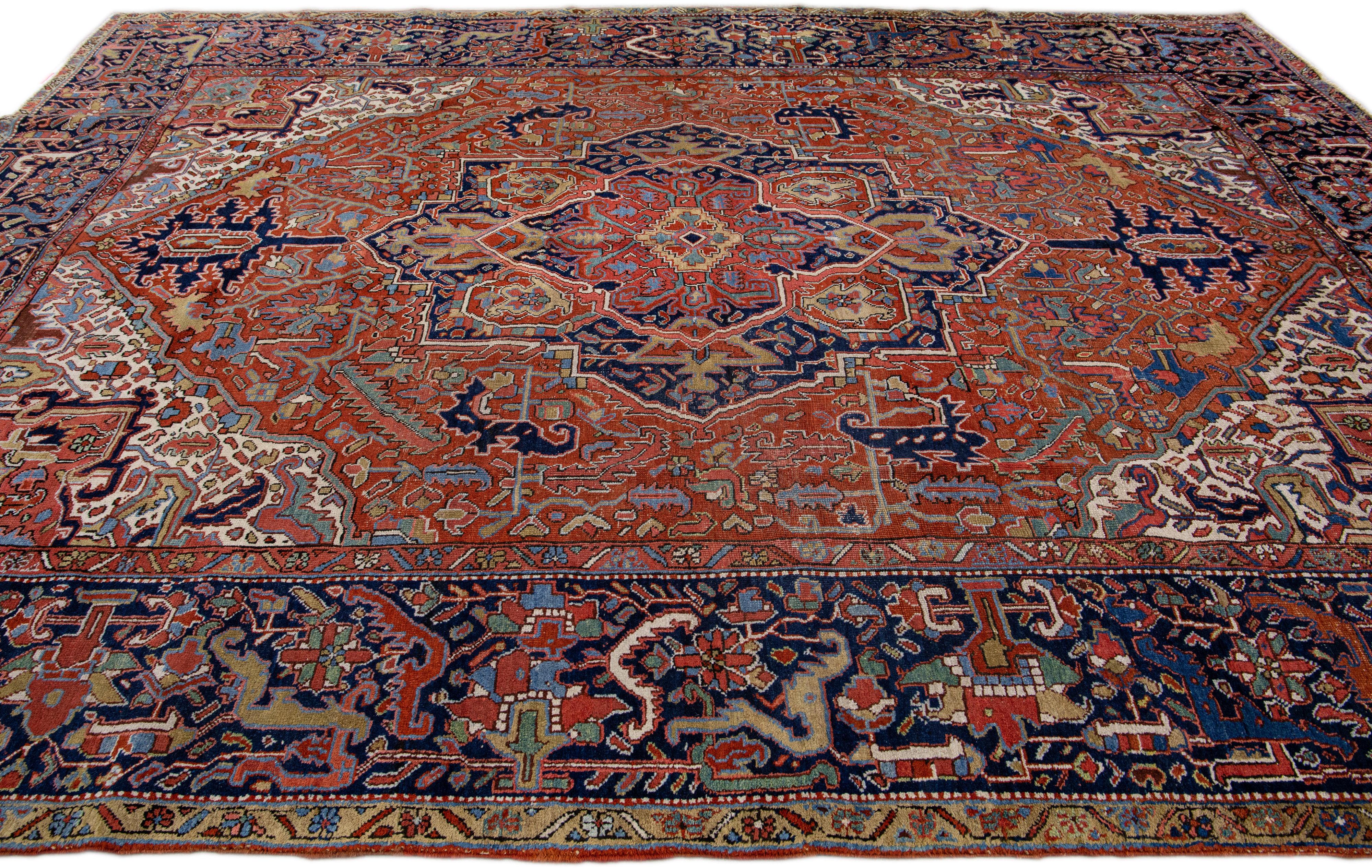 20th Century  Antique Persian Heriz Handmade Rust Wool Rug with Medallion Design For Sale