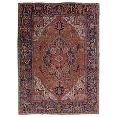 Tapis persan ancien Heriz en laine rouille fait à la main avec motif de médaillon
