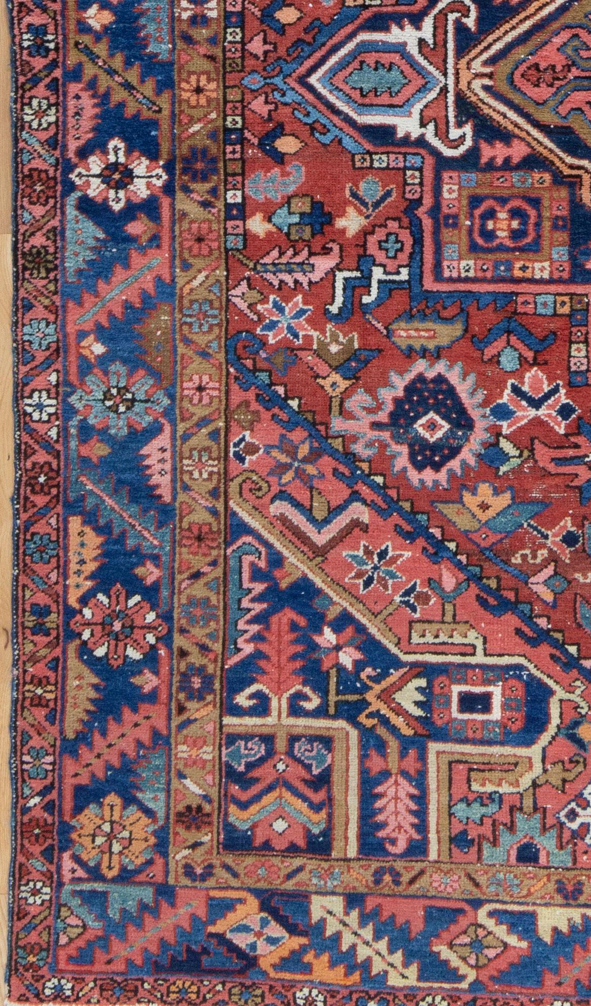 A richly colored Karadja Heriz from Northwest Iran. A tribal rug from a mountain region that utilized high quality wool and natural dyes. The madder red, indigo blue, pink, camel and jade green have beautifully softened over the past century. In