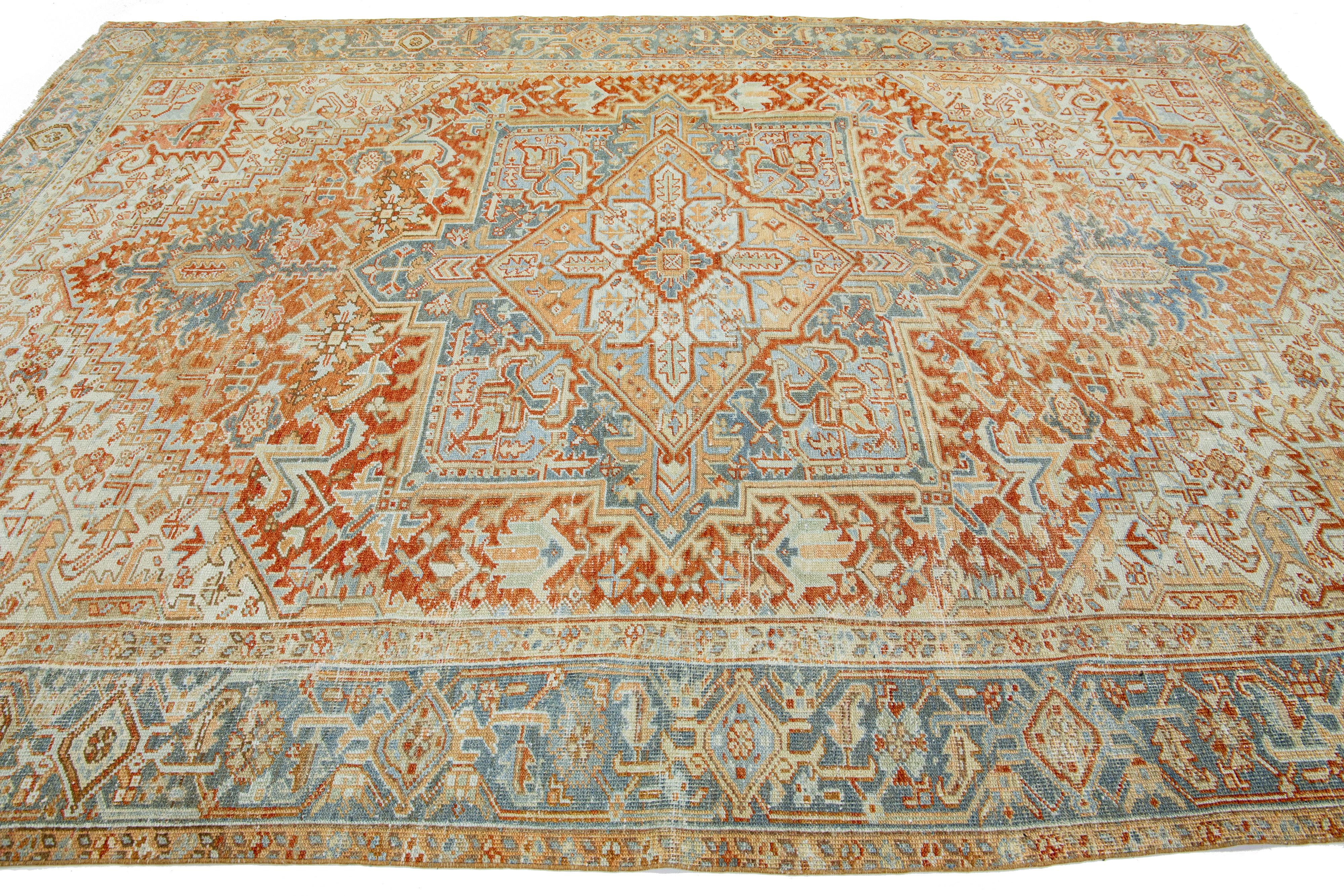 Hand-Knotted Antique Persian Heriz Orange Wool Rug Featuring a Medallion Design For Sale