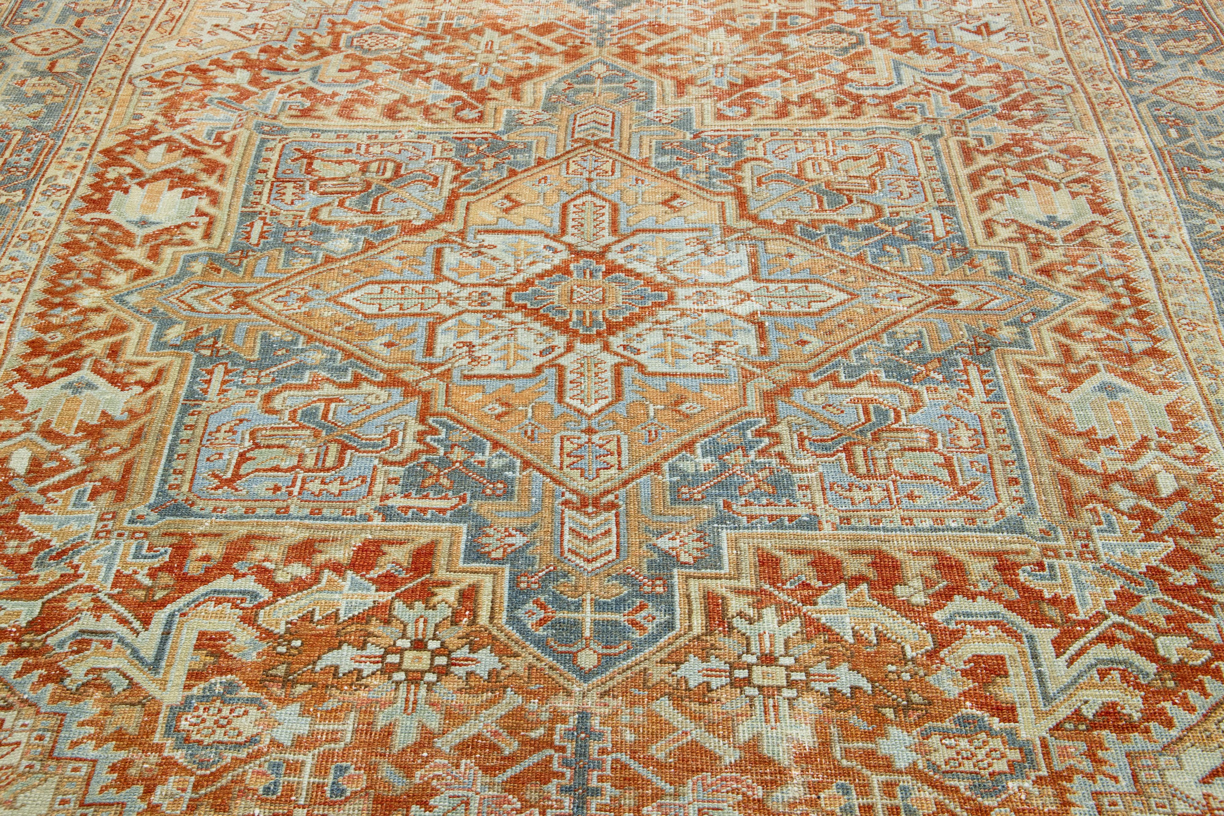 Early 20th Century Antique Persian Heriz Orange Wool Rug Featuring a Medallion Design For Sale